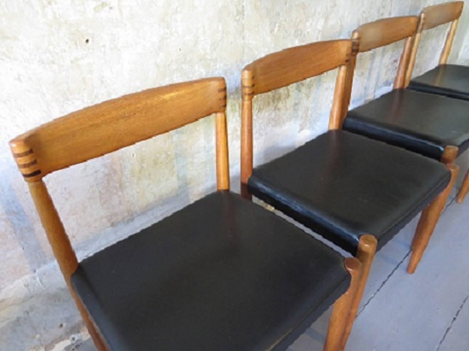 Set of four teak dining chairs by H W Klein for Bramin dating from circa 1960.
The nicely shaped teak backs are decorated with rosewood inlays.
The seats have their original black leather coverings.
 