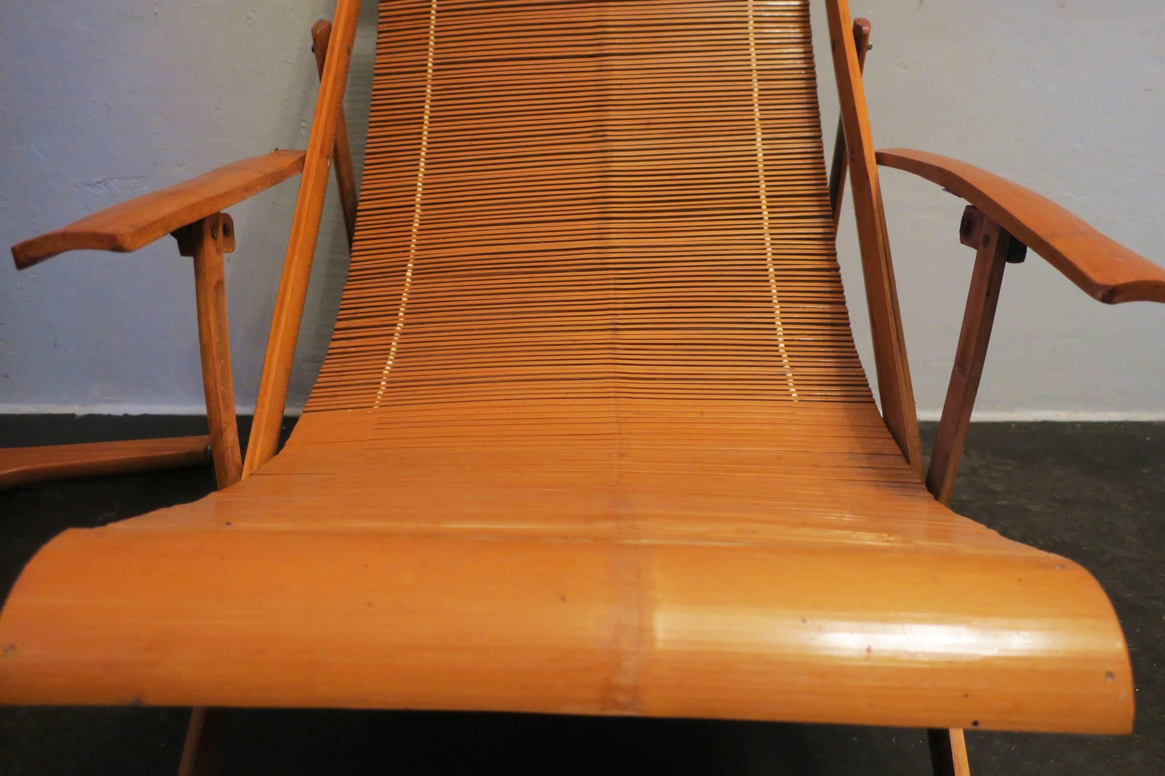 An unusual pair of mid century deck chairs finely made with bamboo slats, adjustable to six positions probably Japanese.