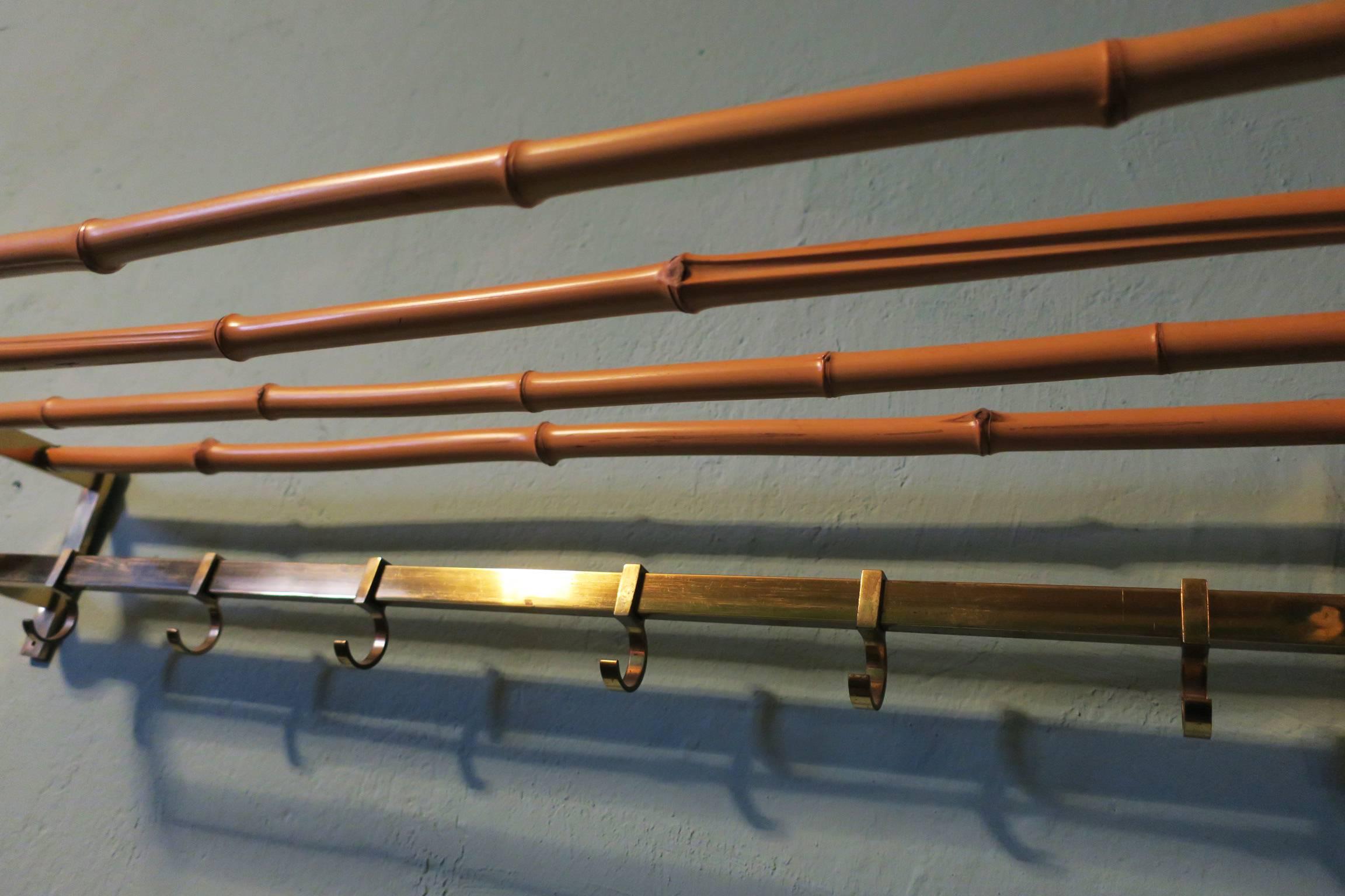 Vintage brass and bamboo coat rack with sliding hooks.