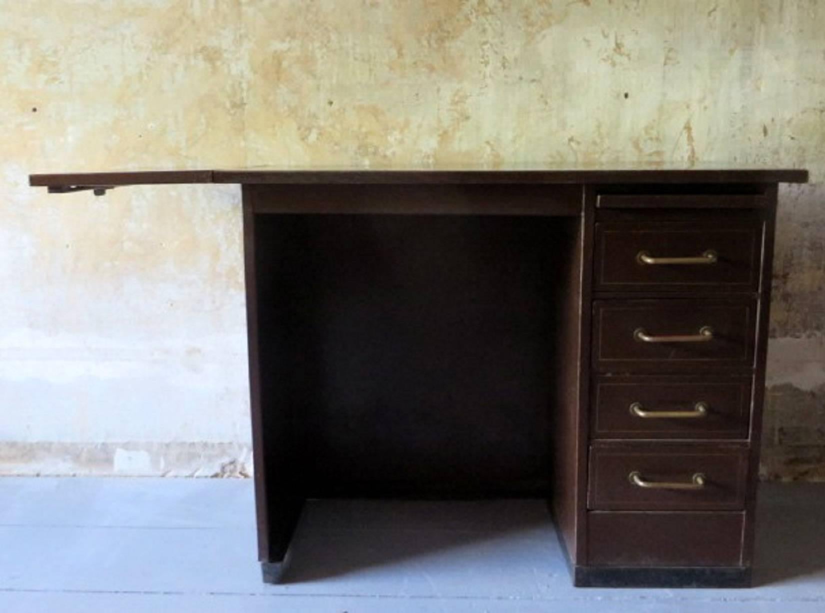 Very pretty French industrial metal desk from about 1940-60 with painted gold-colored inlay on the top and around the drawers.
Brass handles.
The desk has a flap to extend the width.
Nicely patinated.
Small size. The desk is 92cm wide with the