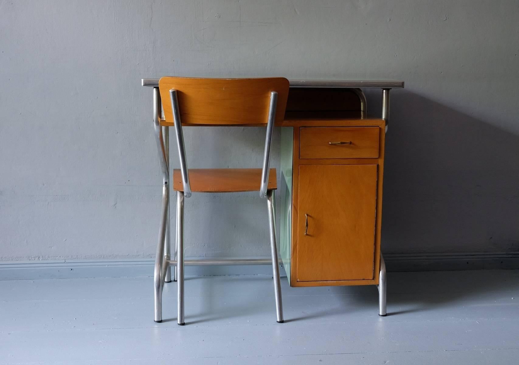 This desk and chair were produced in Italy during the 1950s and are made from metal, wood, and formica. 
The set is small but both the seat and the desk are of full height at 44 cm / 17