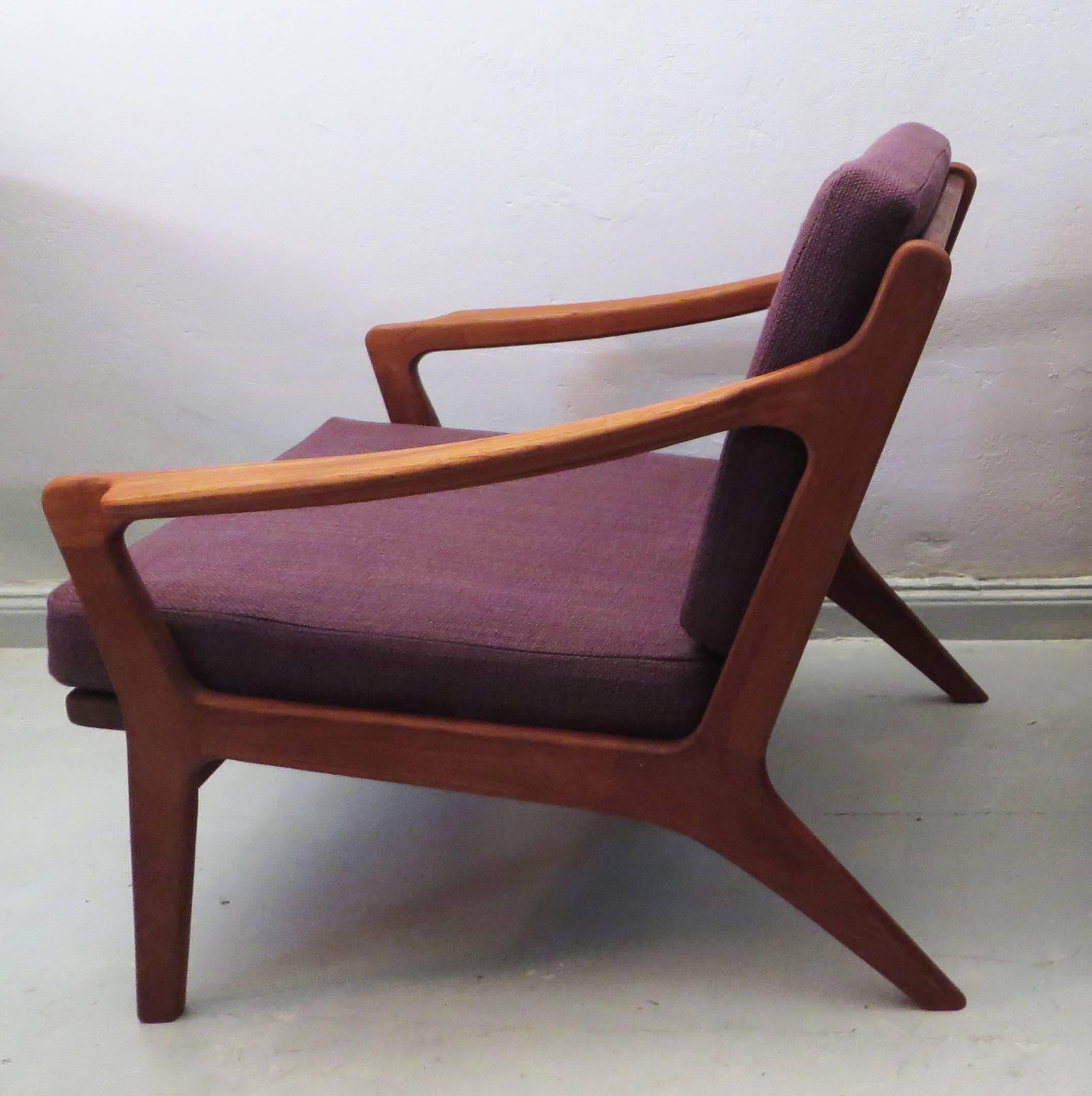 Elegant teak lounge chair from Denmark 1960s with a Fine and striking design. The cushion covers are recent but in 1960s style with a 