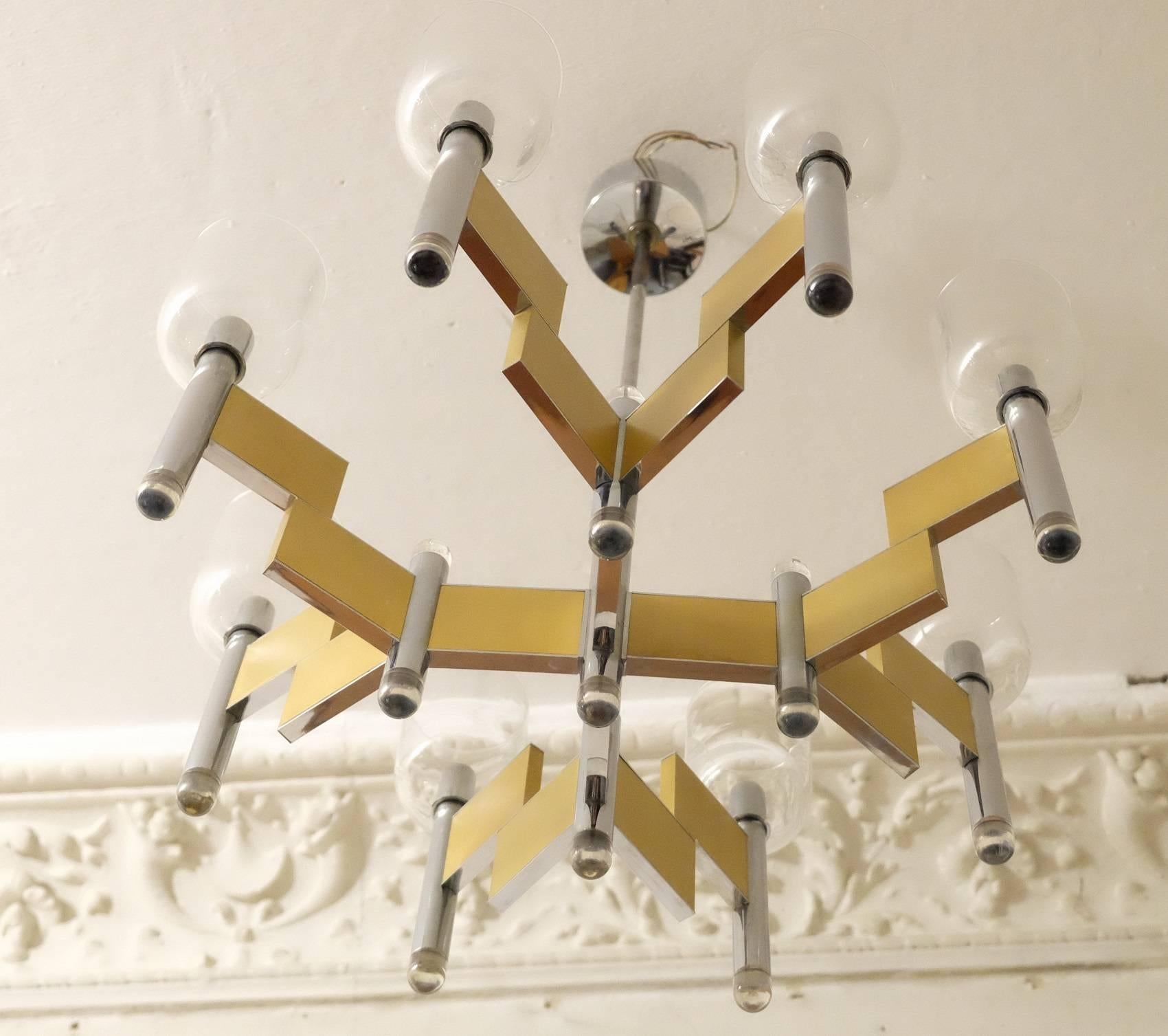 Italian brass chandelier with a geometrical design, fine glass shades and lucite caps on the frame ends.