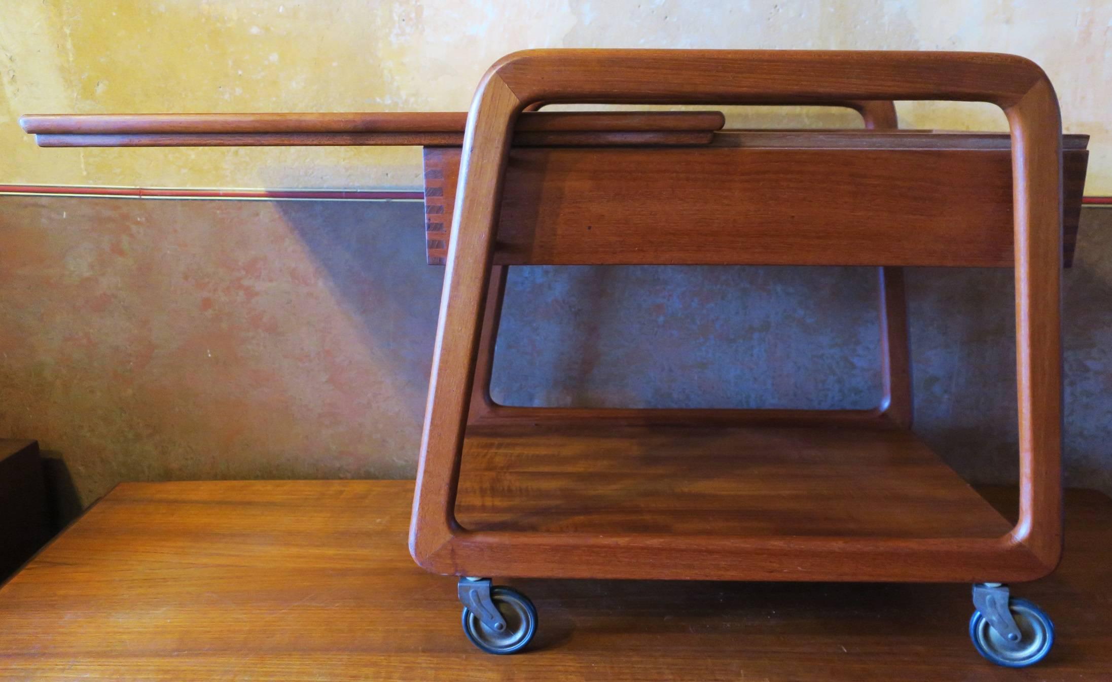 Danish teak trolley with sliding top, Midcentury. The trolley has a useful sliding tray under the sliding top with small compartments.