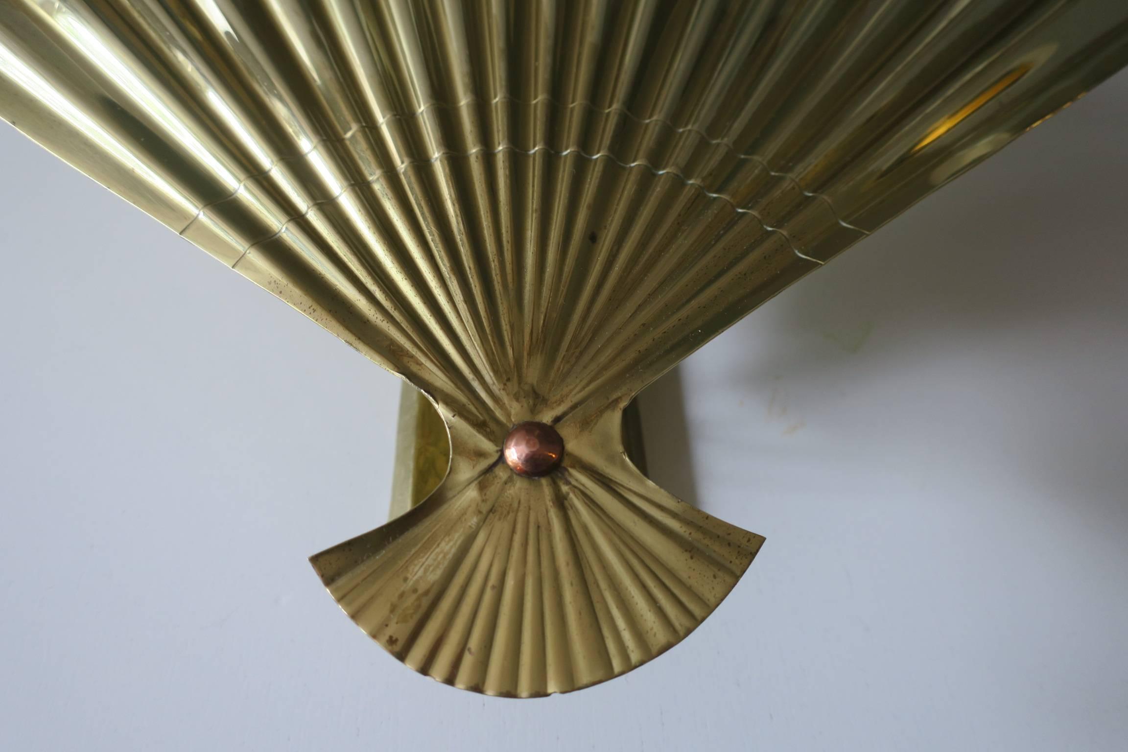 Brass sconce in the shape of a fan, Mid-Century, probaly Italian.