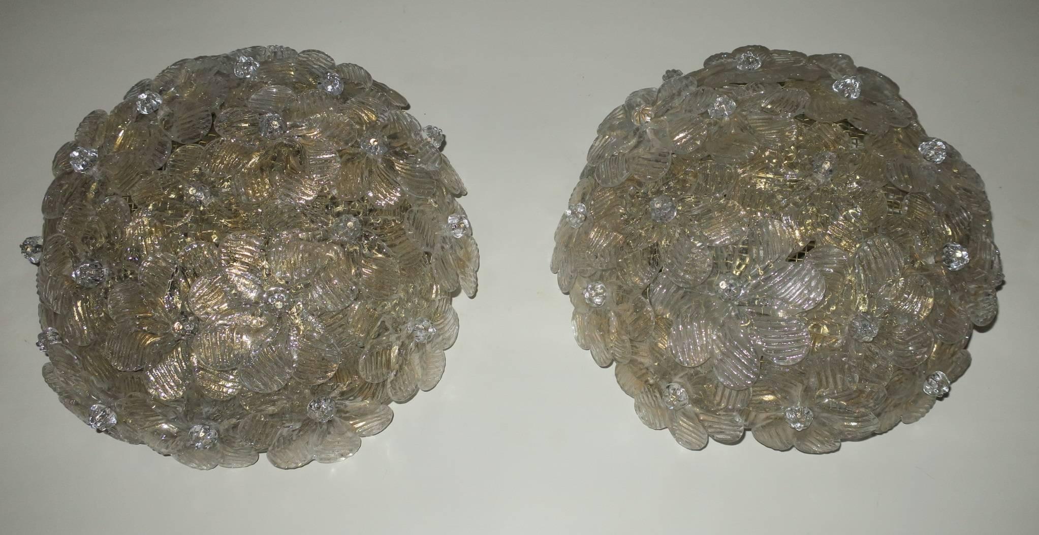 Pair of Barovier and Toso millefiori sconces or flush mount lights from the 1950s.

Fine glass flowers speckled with gold.

Each with two candelabra bulbs.

Takes standard US or European candelabra bulbs.
  