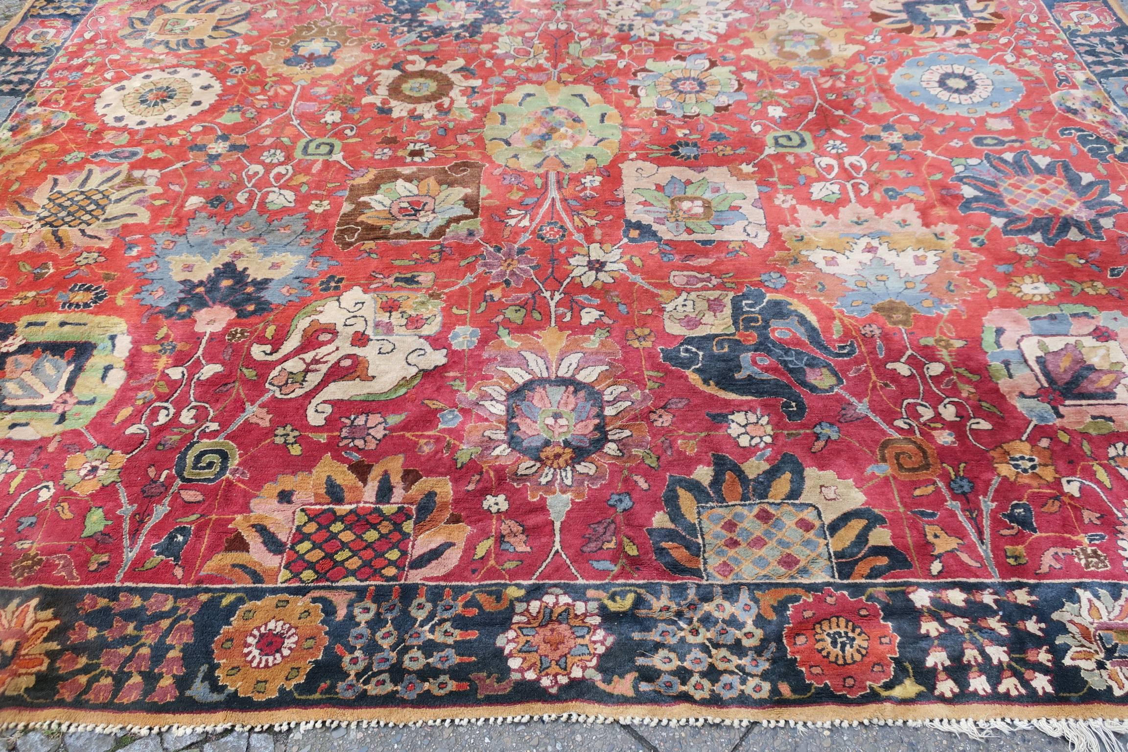 European hooked carpet probably Austrian or German dating from the early part of the 20th century. The rug has very beautiful colors and a classical 'Shah Abbas' or 'Vase' design of large palmettes on a soft red background. It is in very good