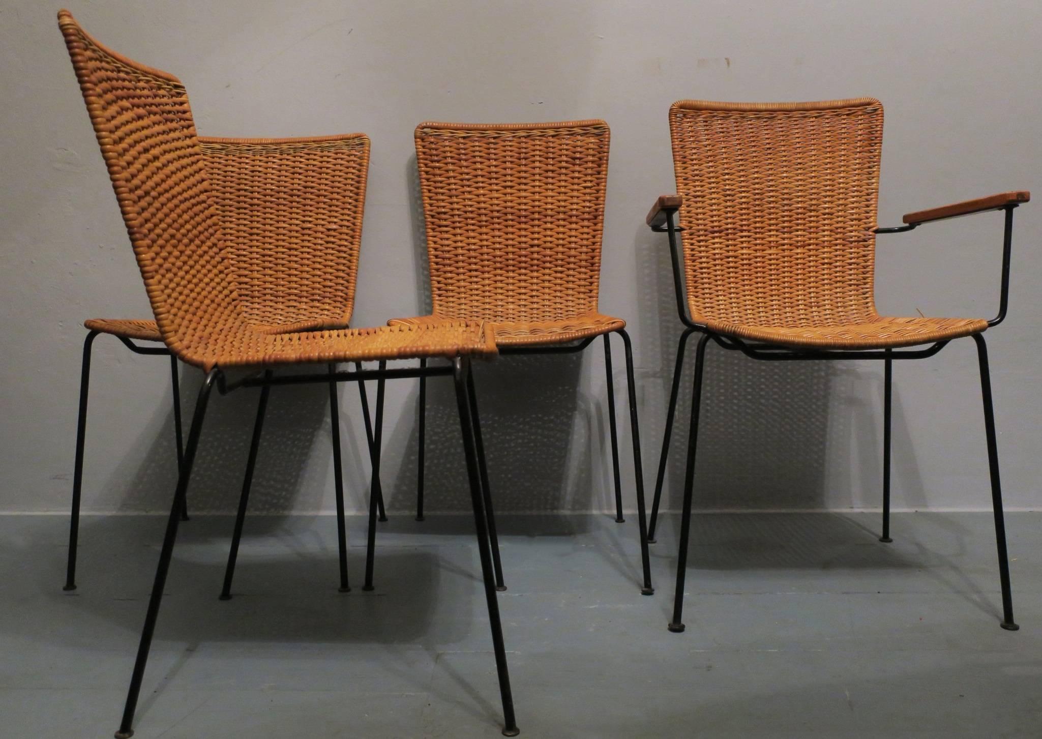 A set of four midcentury rattan dining chairs on slender iron frames, one chair with armrests.
All in very good condition.