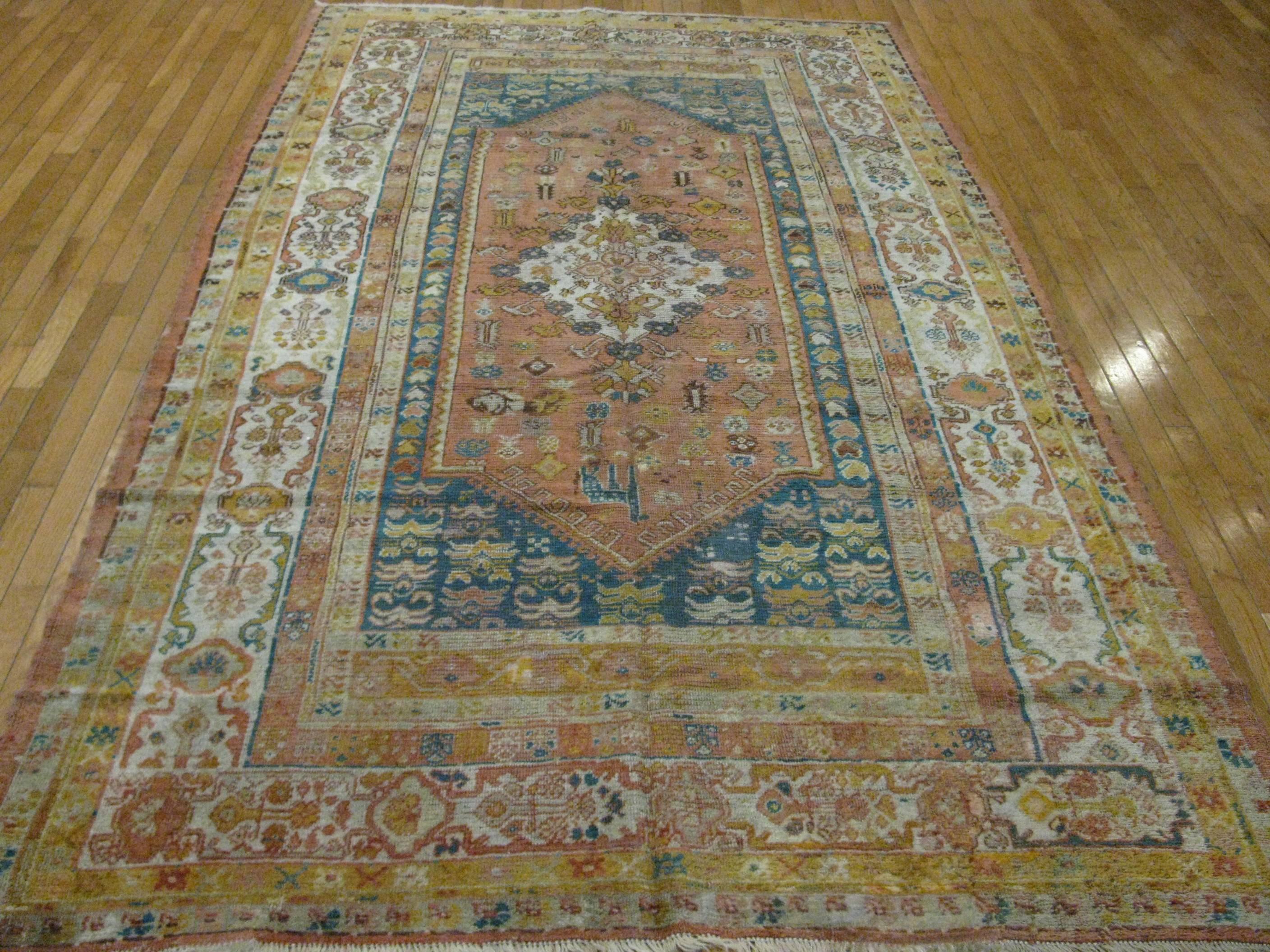 This is an antique hand-knotted Turkish Oushak rug with a finely hand-knotted construction with angora wool and natural dyes in a detailed traditional pattern, circa 1900.