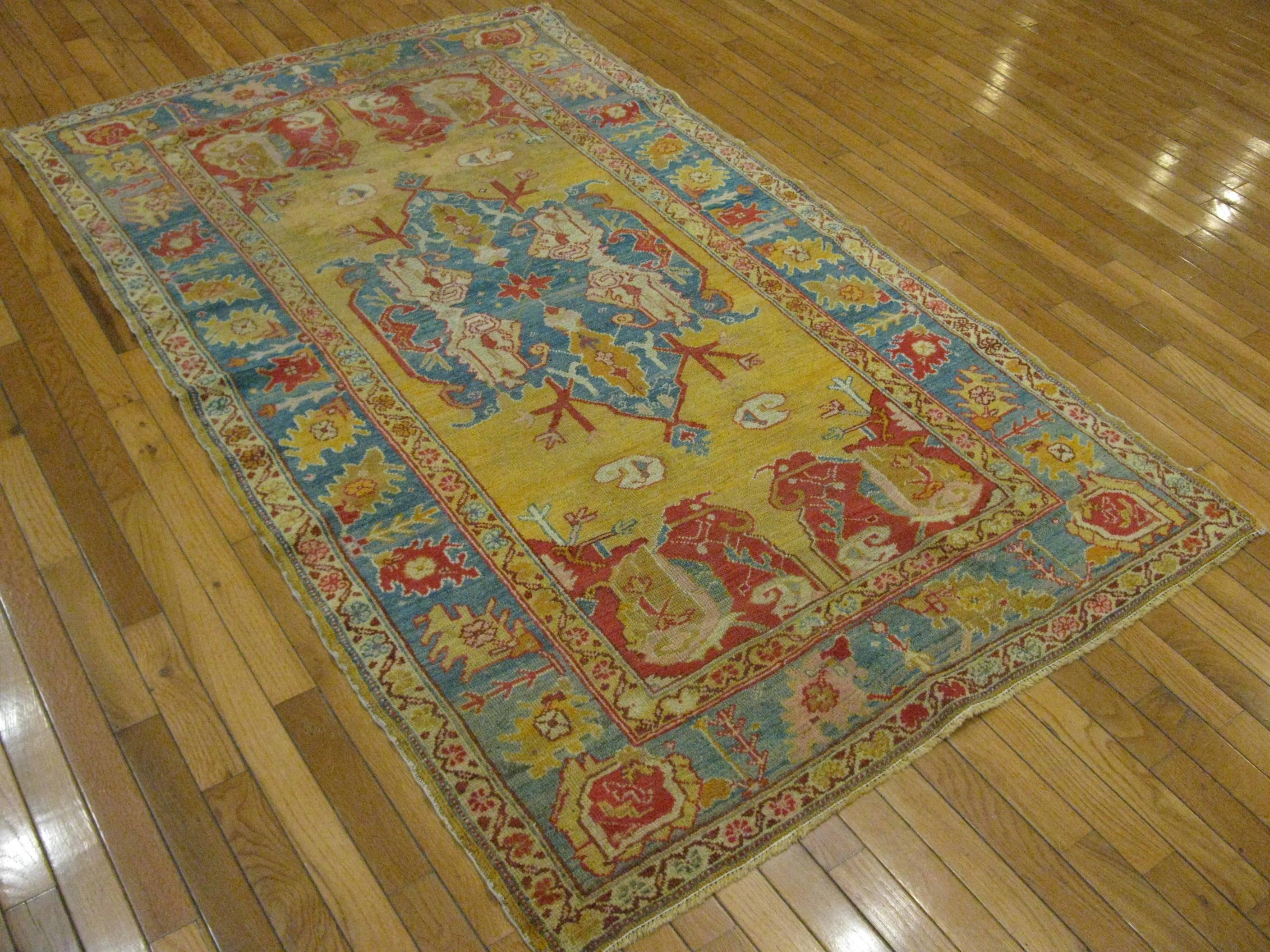 This rug is a small finely hand-knotted genuine antique Turkish Oushak rug with an elegant traditional geometric design made with fine wool and rich natural color dyes. It is in very good condition.