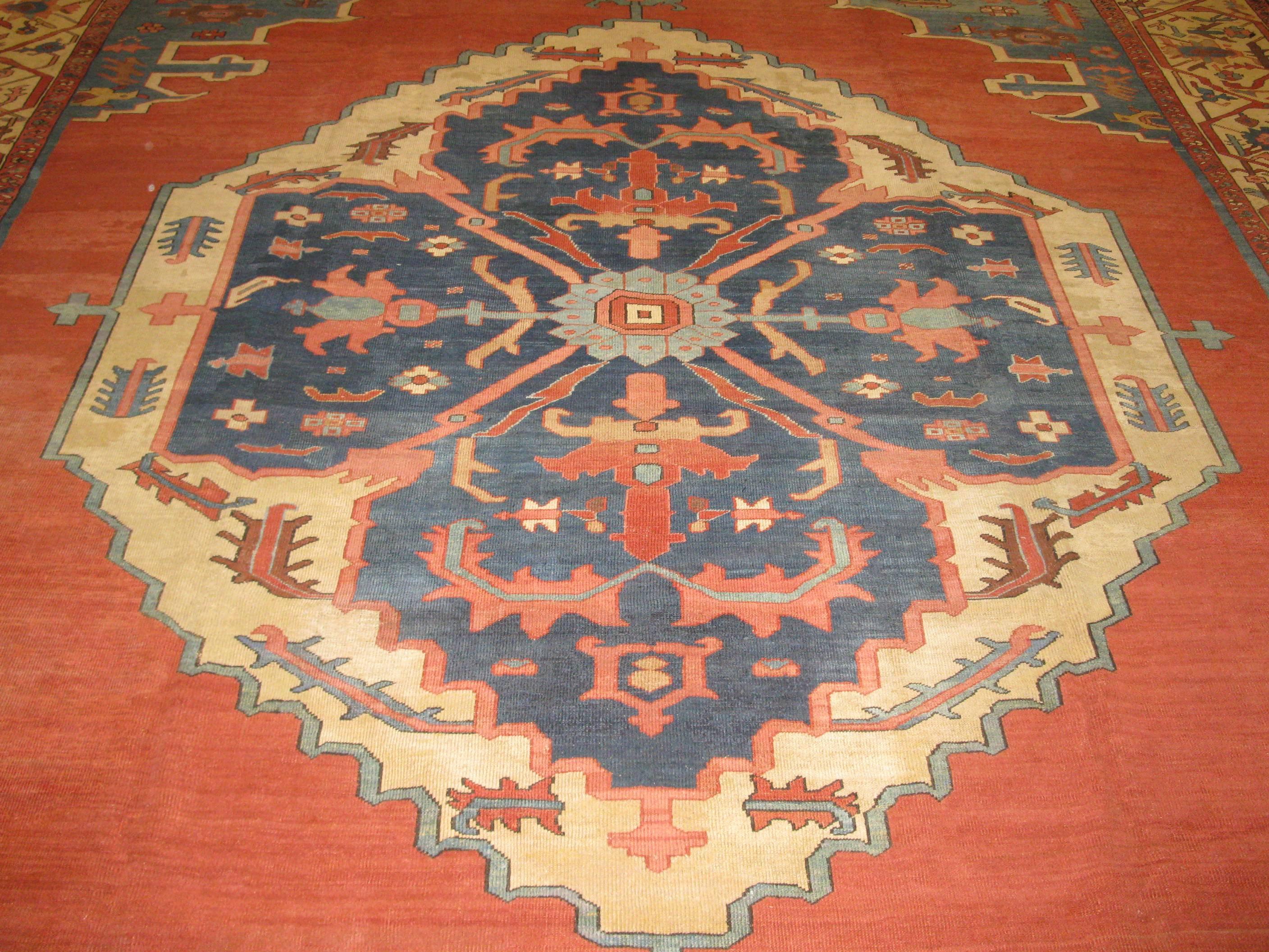 This is a beautiful example of the late 19th century antique Persian Bakhshayesh rugs with a bold medallion on an open solid brick red color background. The rug is in great shape, circa 1890.