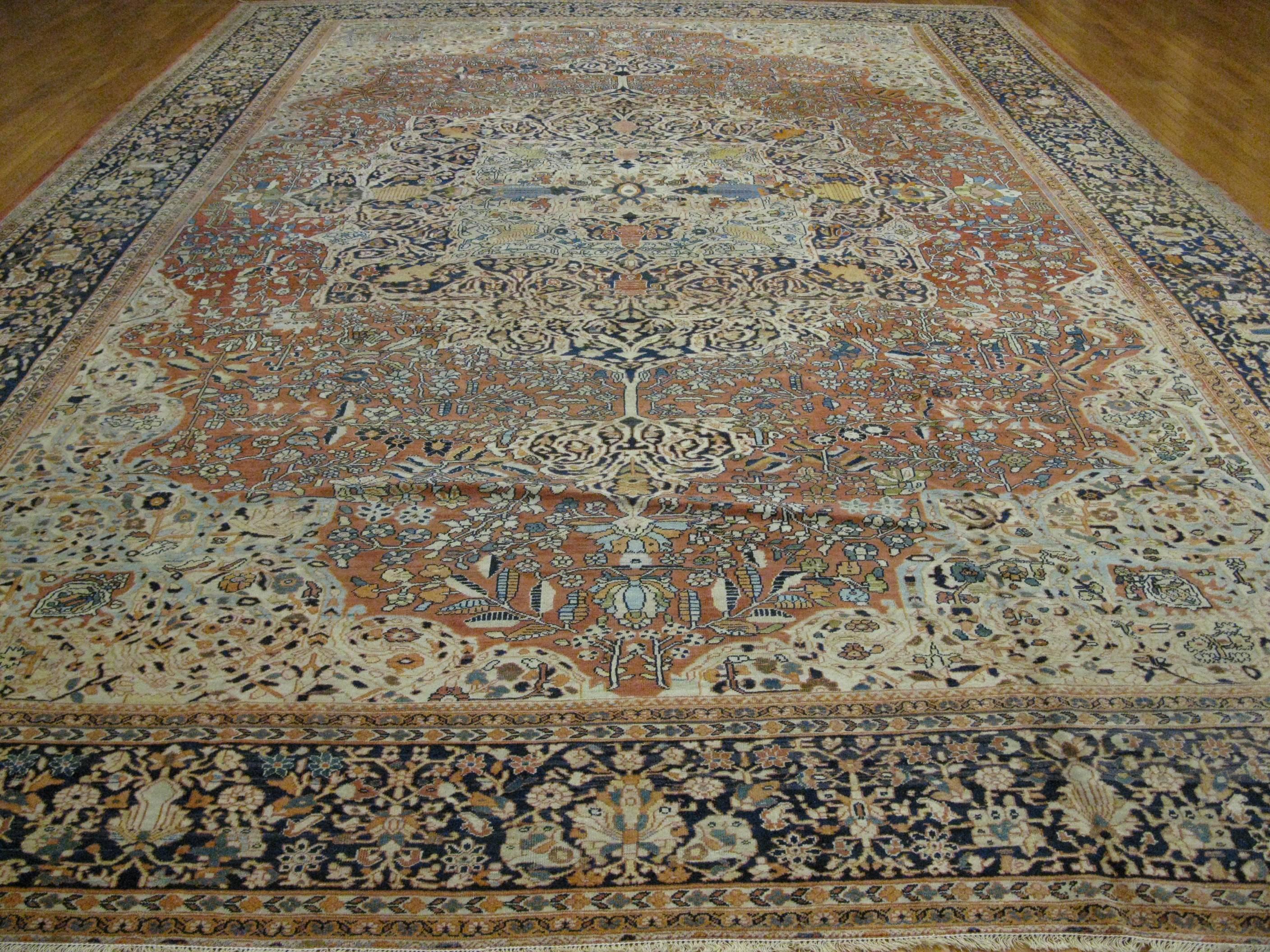 A fabulous antique hand-knotted Persian Sarouk Farahan of late 19th century. It has a traditional detailed pattern made with fine wool on a cotton foundation colored with all natural dyes. It measures 12' 8