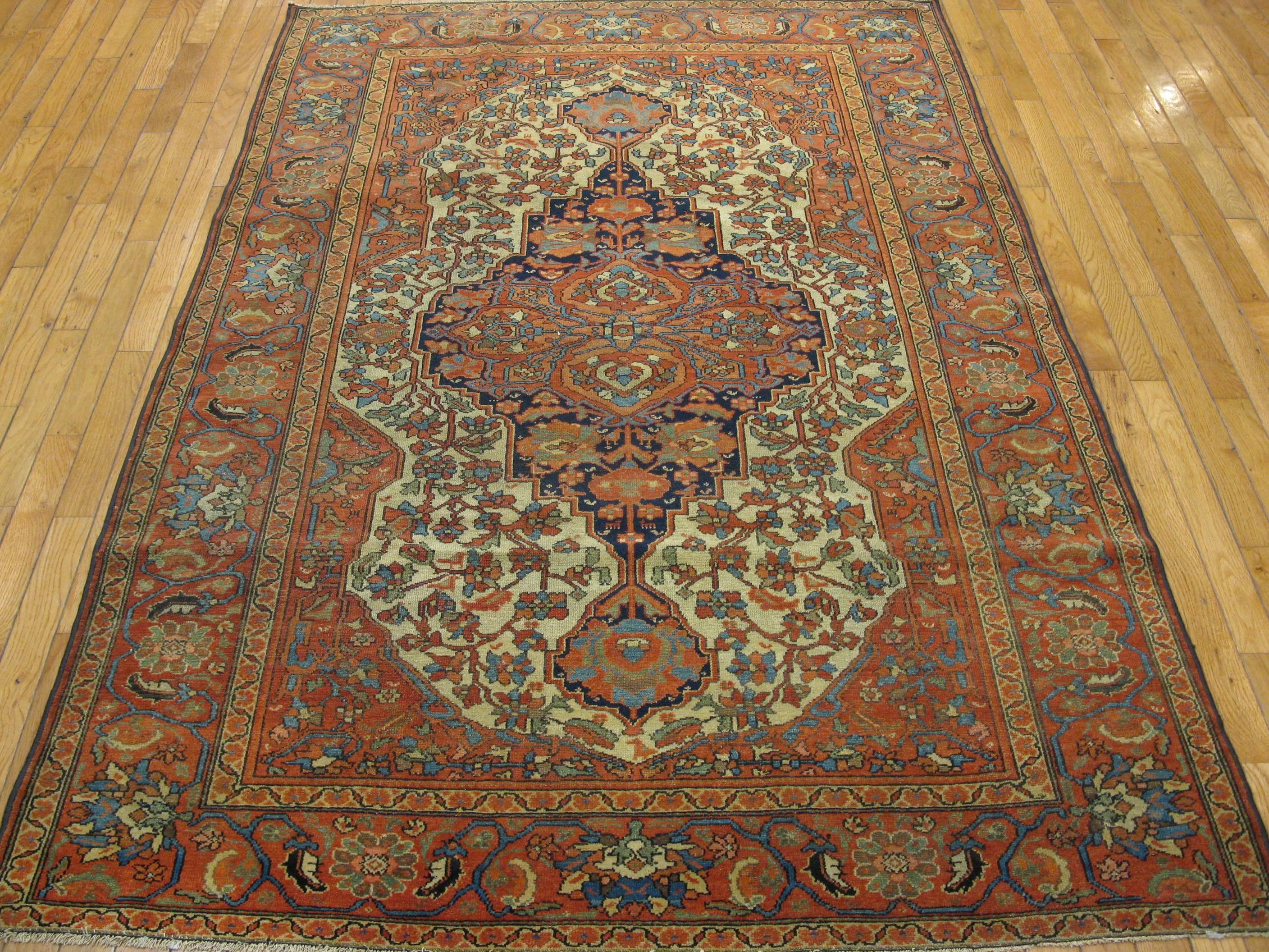 A small antique hand-knotted rug from the city of Malayer in west central Iran. The rug measures 4' 5'' x 6' 6'' made with wool pile and cotton foundation. It represents the finer quality rugs from this area.
