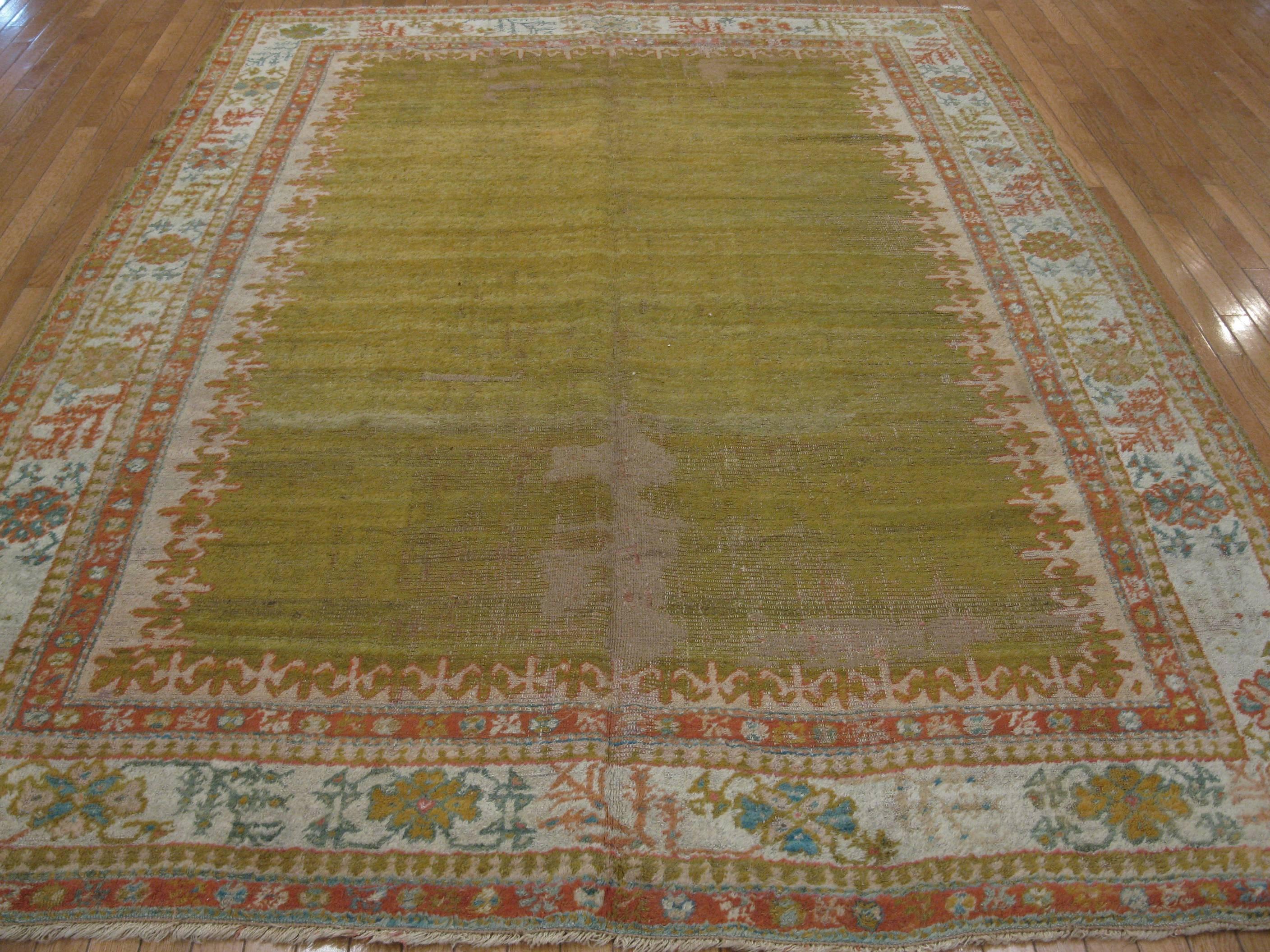 This is an antique  handmade Turkish Oushak rug. It is made with 100% fine angora wool colored with all natural dyes. It measures 7' x 10'.