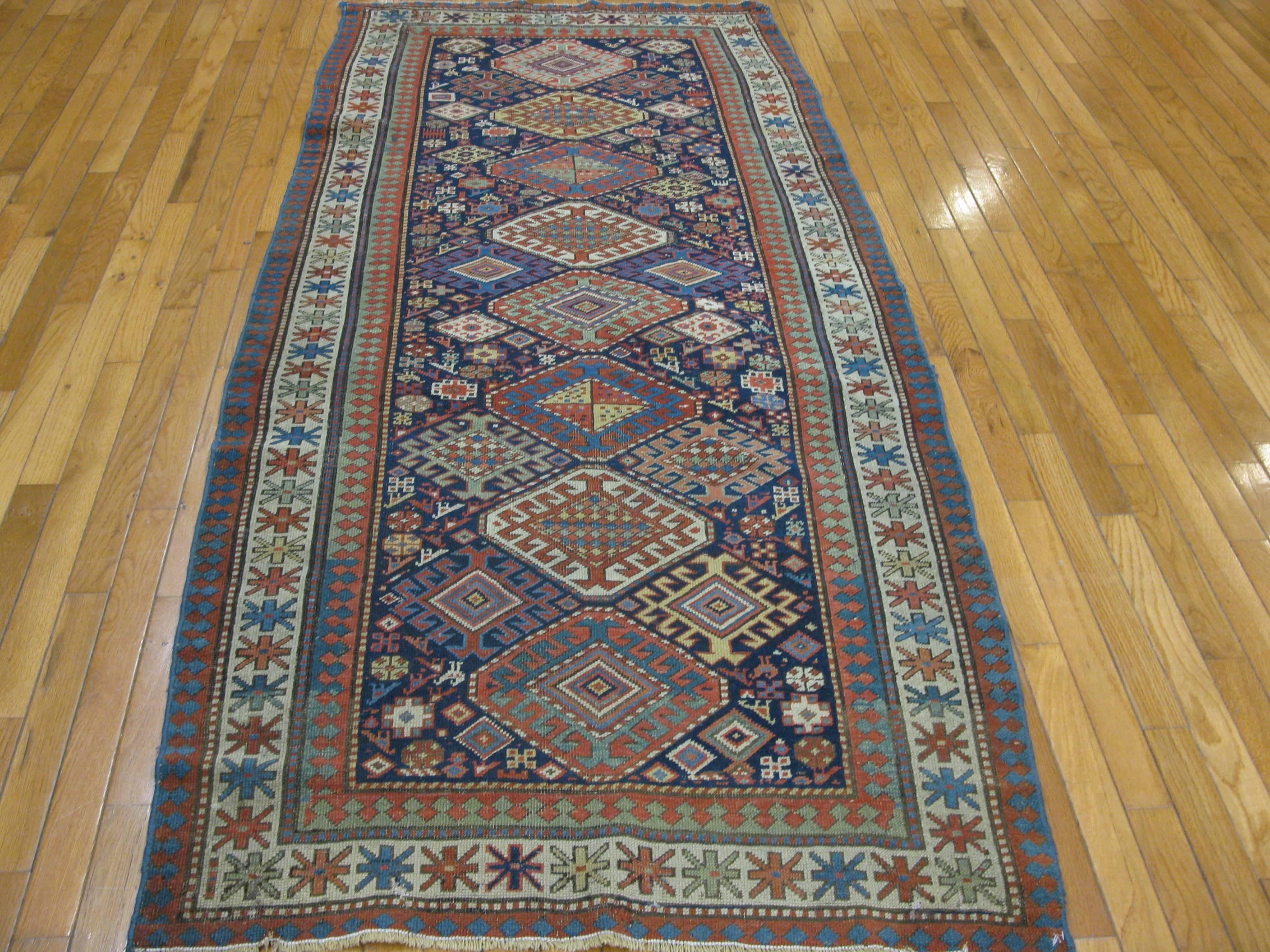 This is a beautiful antique hand-knotted late 19th century Caucasian Shirvan rug. It measures 3' 5'' x 7' 6'' and it's made of wool and all natural dyes.