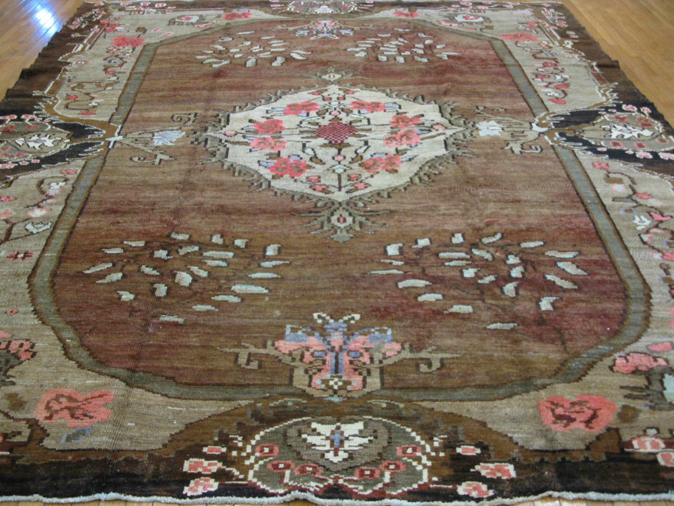 This is a very unique hand-knotted Turkish rug with a country French style design. It measures 9' 6'' x 11' made of wool pile and cotton foundation with all natural dyes in primary colors.