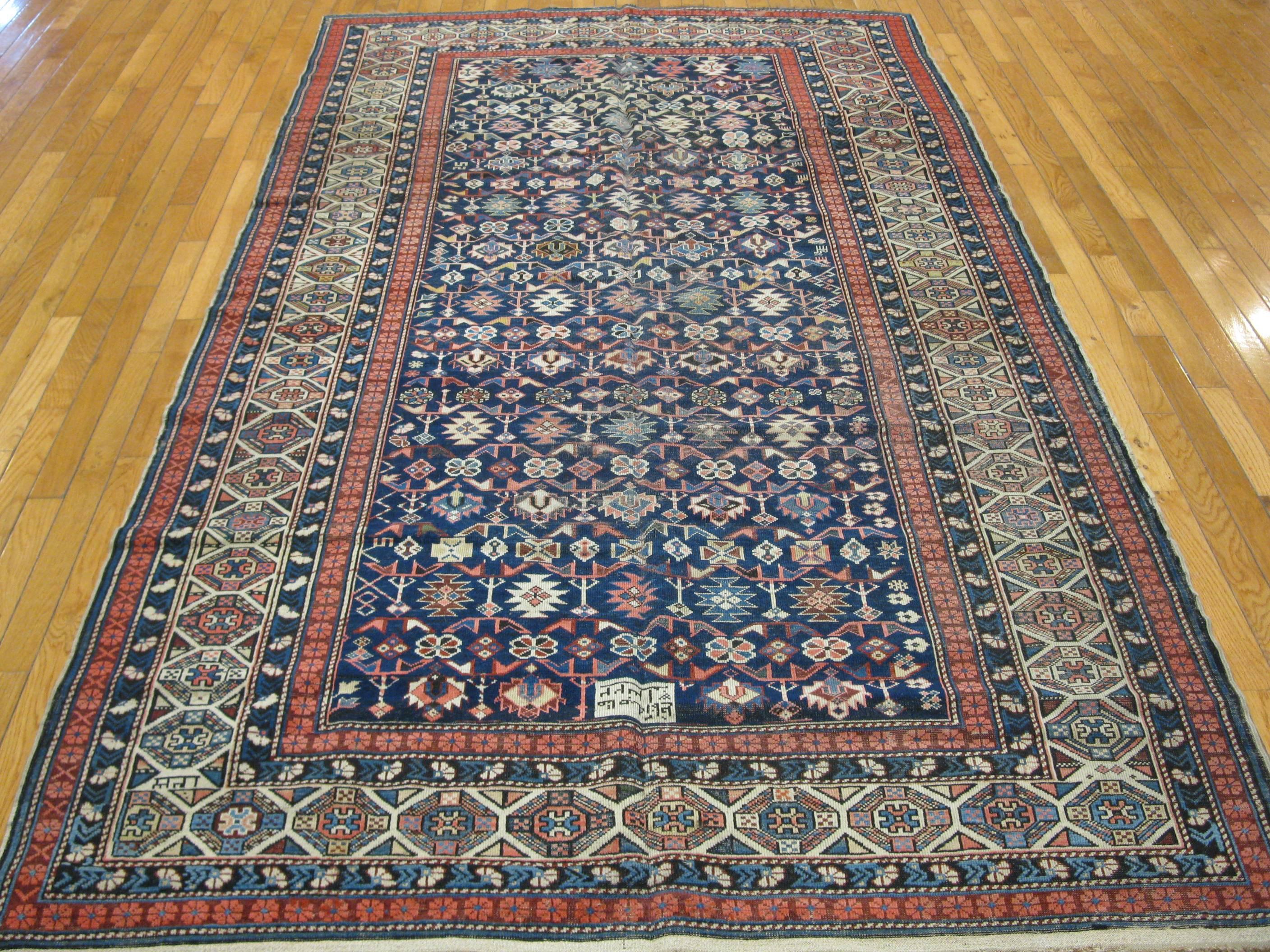 This is a fabulous antique hand-knotted Caucasian Shirvan rug. It has an all-over small scale repetitive geometric pattern wrapped around with a multi band border. The rug measures 5' x 8' 7'' . It is dated 1322 in Islamic calendar which make it