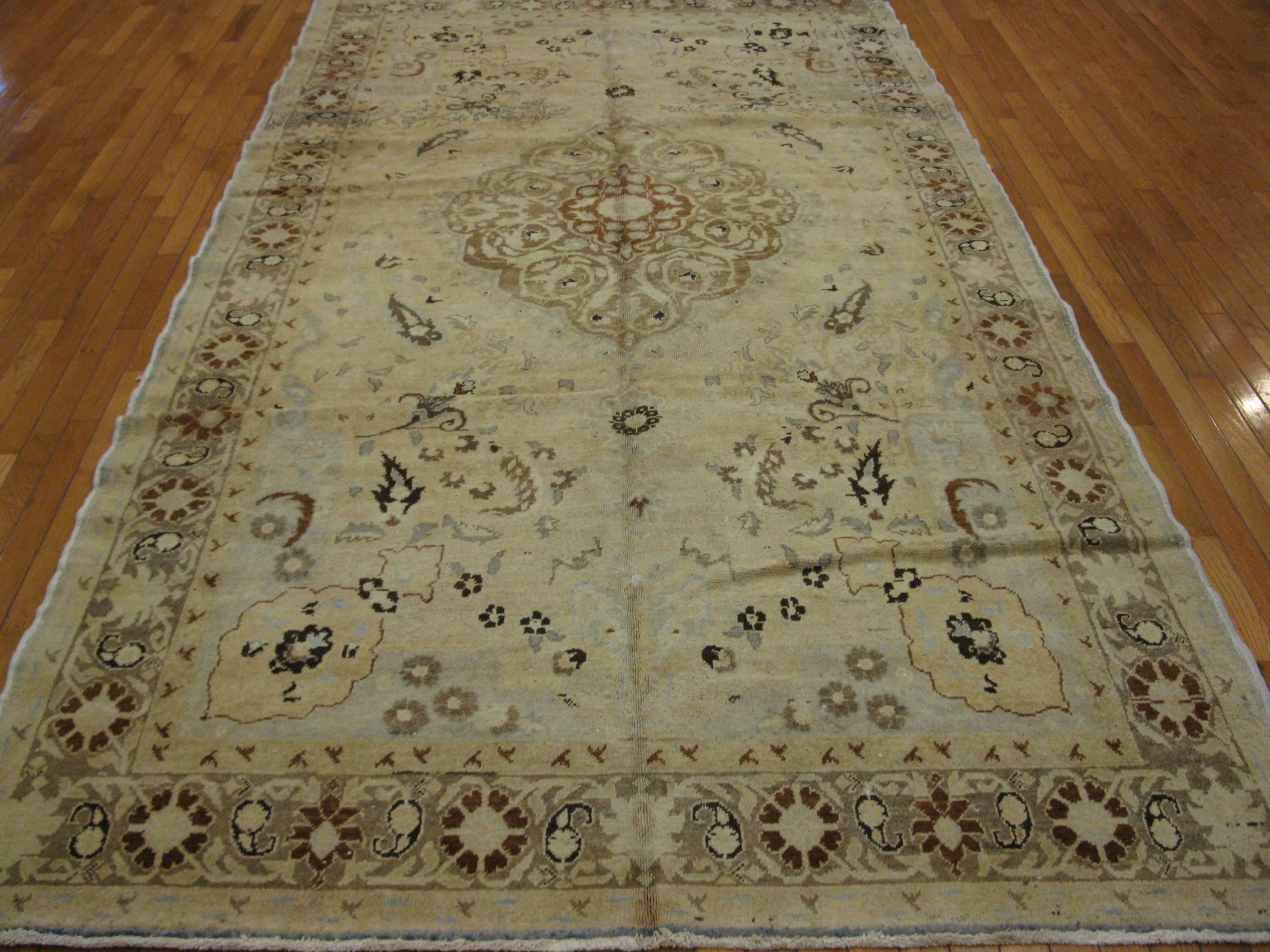 This is a beautiful and elegant hand knotted Turkish rug with soft colors and a detailed pattern in a traditional central and corner medallion design. The rug measures 5' 10'' x 11' 2''.