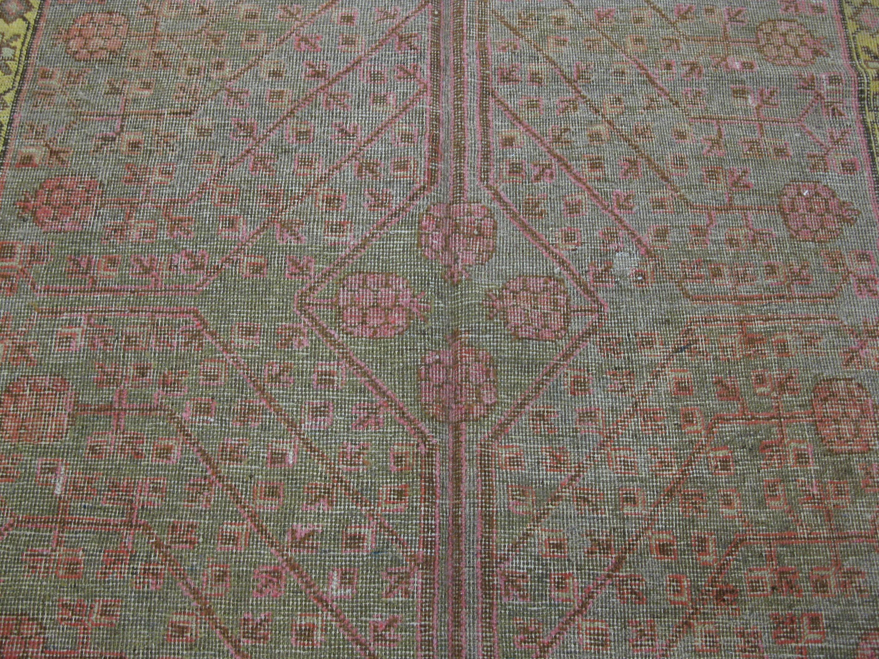 This is a beautiful and unique hand-knotted antique Khotan rug in a gallery size that measures 5' 2'' x 10' 5'' . The rug has a very unique and detailed design not commonly seen in these type of rug.
 