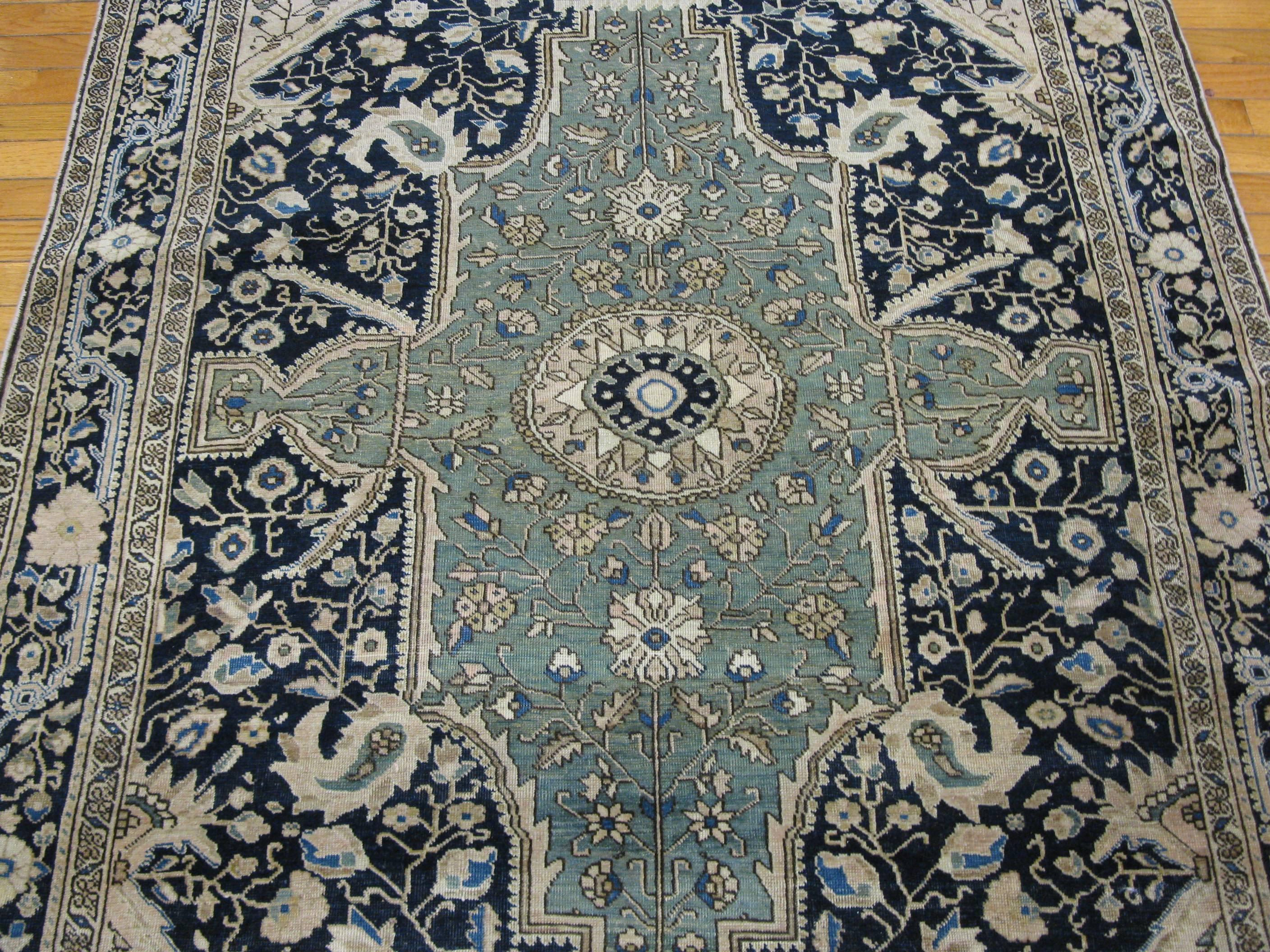 This is a beautiful and rare color combination antique hand knotted Persian Sarouk Farahan rug. It has traditional corner and central medallion design. The rug measures 4' 3'' x 6' 4''. It is in excellent condition.