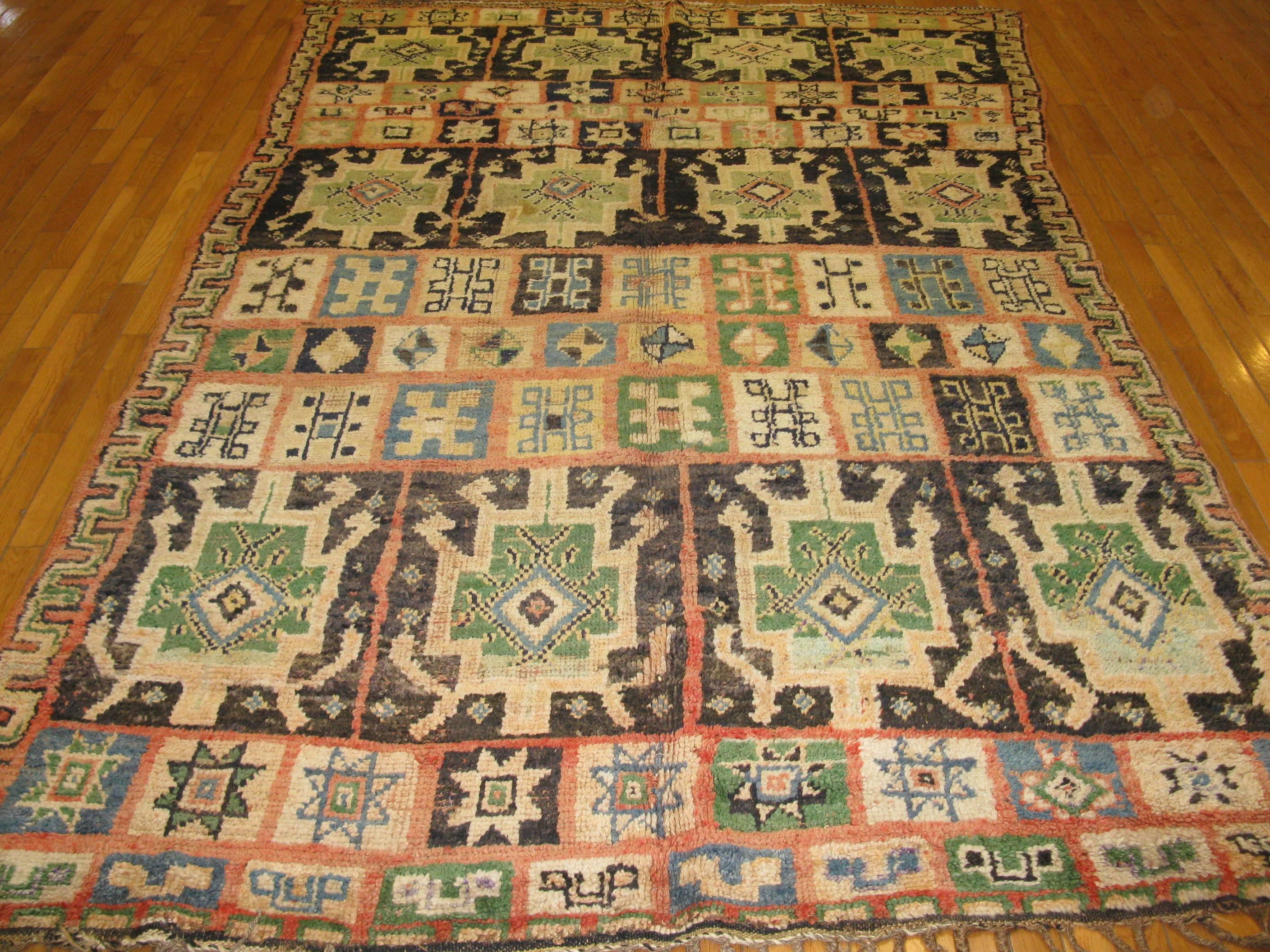 This is a tribal hand-knotted rug from Morocco. It is made with all wool and natural dyes. The rug is in great condition and measures 5' 10'' x 8' 11''.