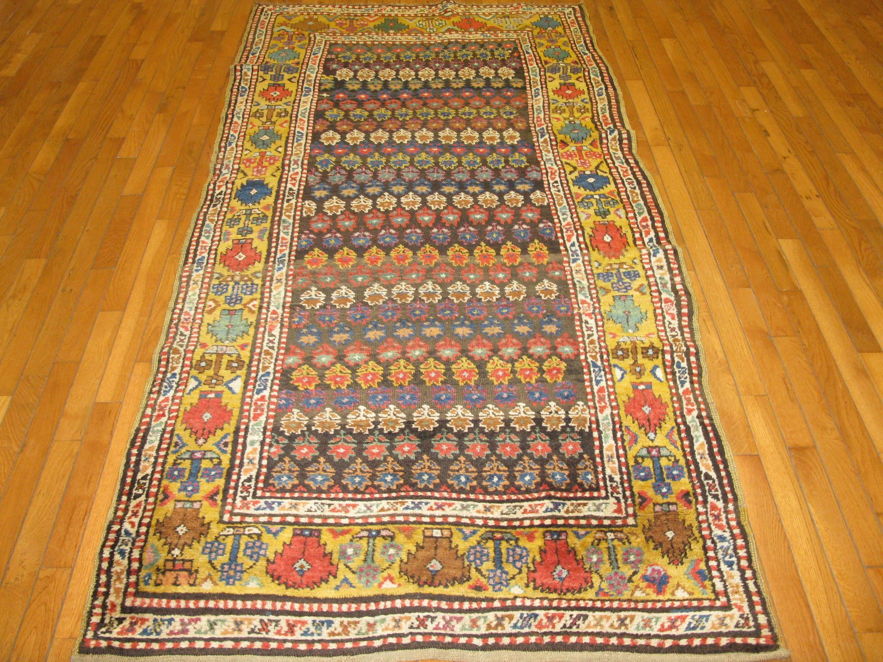 Beautiful and rare short runner antique Kazak rug. It has an all-over pattern hand-knotted in rich multiple colors. The rug measures 3' 8'' x 7' 8'', it is in great shape and made with all wool and natural dyes.