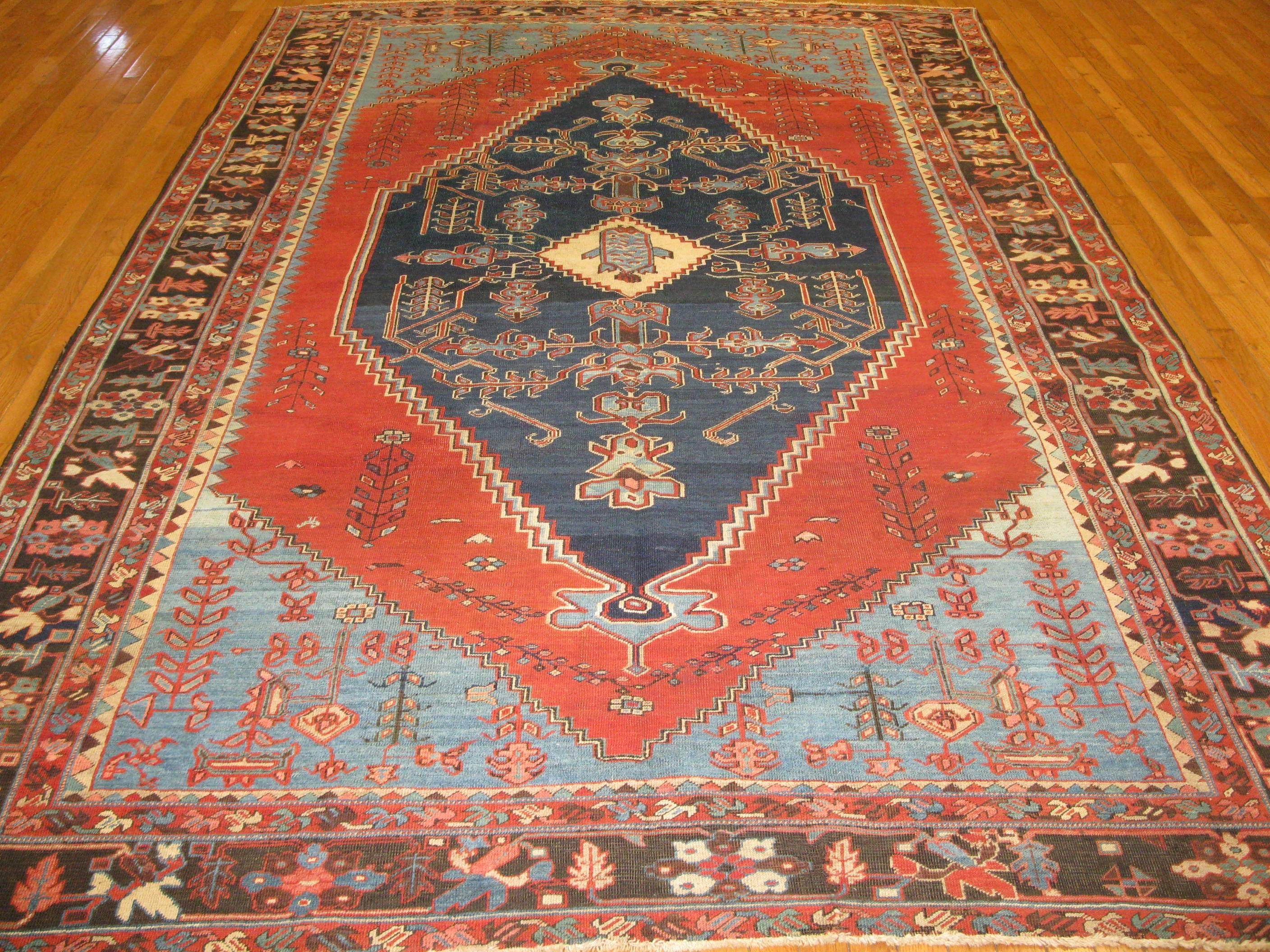 This is an outstanding room size antique hand-knotted Persian Bakshaish Serapi rug. It has a distinct pattern made with wool pile cotton foundation. The rug would be beautiful addition to any decor. It measures 7' 1'' x 11' 1’’.