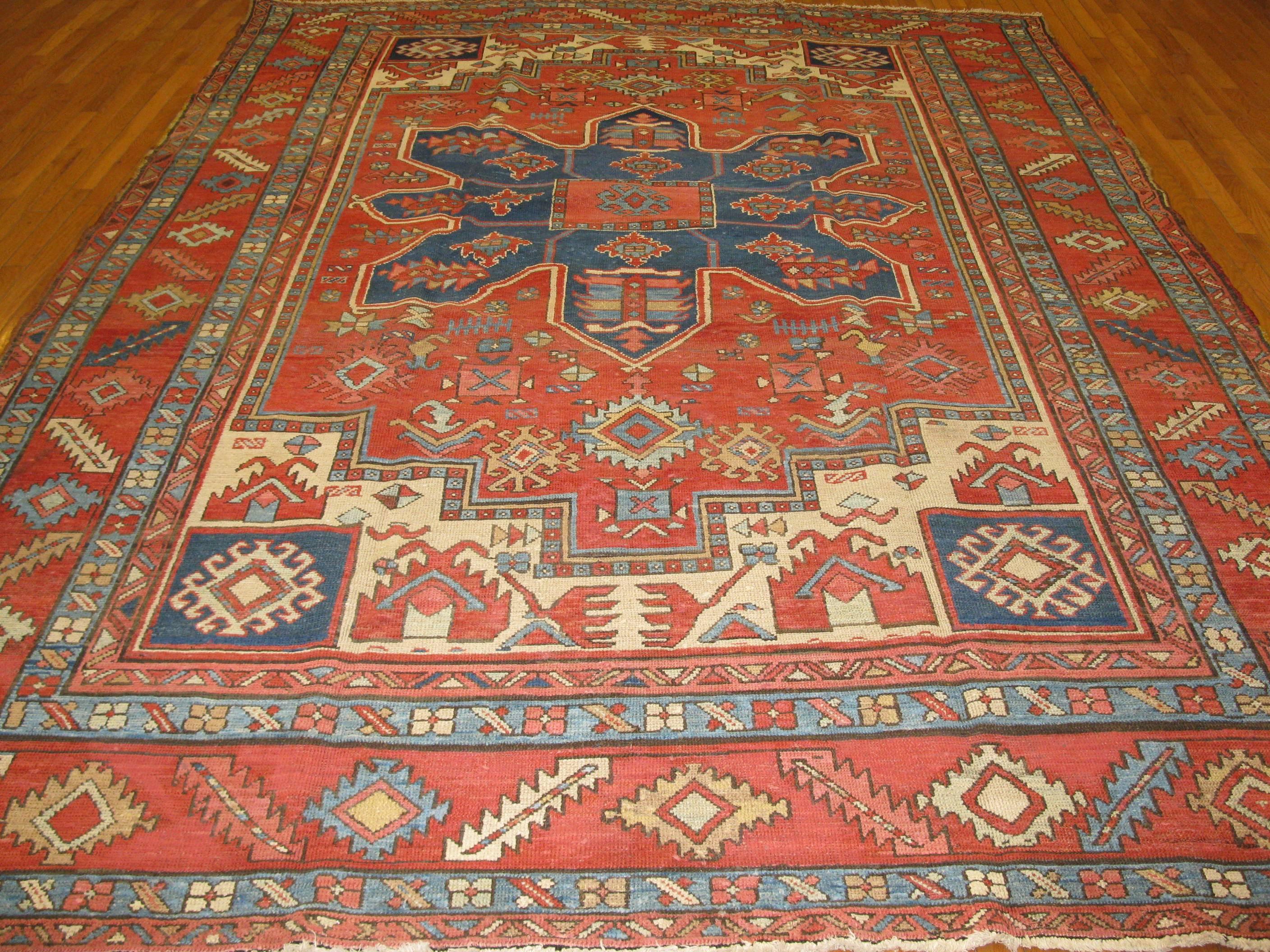 This is a room size simple pattern traditional tribal looking Persian Serapi rug.
It measures 9' x 11' 5'' with rich navy and melon red colors fit to enhance the look of any room.