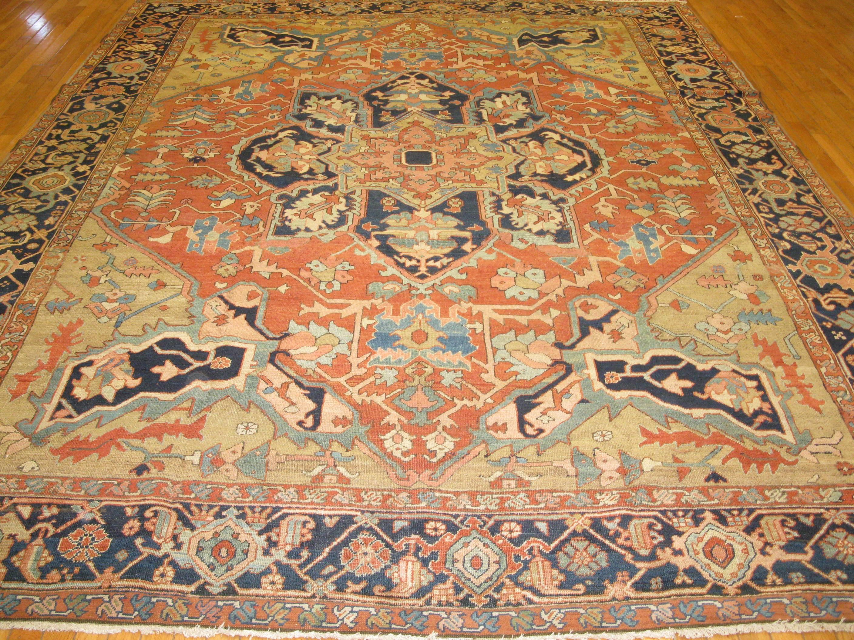 This is a beautiful and finely hand-knotted room size antique Persian Serapi rug. It has a traditional pattern with natural dye colors. It measures 8' 10 '' x 11' 4''.