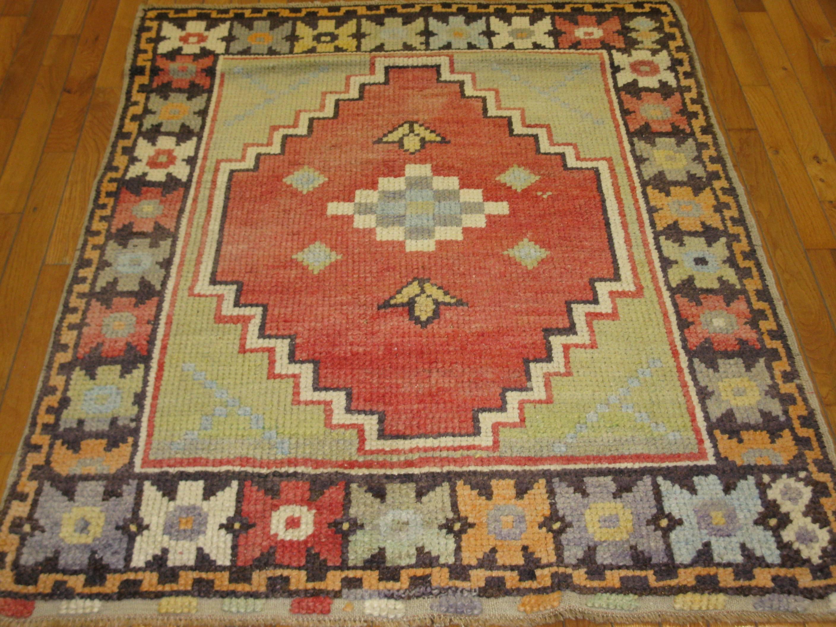 This is a beautiful small hand-knotted vintage rug from the Anatolian region of Turkey. The rug has a tribal design made with all wool and vegetable dyes. It measures 3' 8'' x 4' 8'' and in great condition.