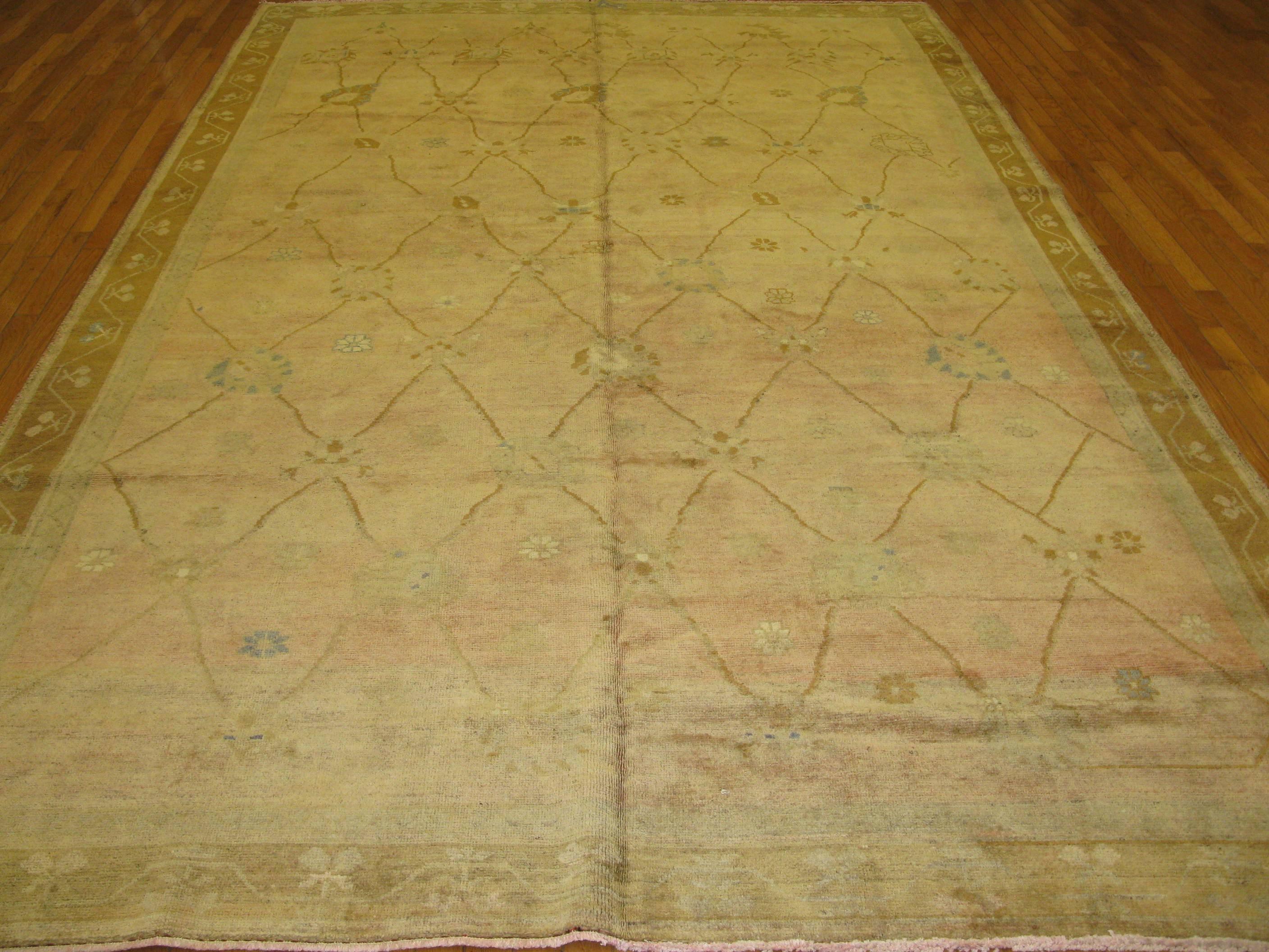 This is a unique hand-knotted antique washed Turkish rug from the Kars area.
It has a beautiful trellis pattern on a soft aged melon color background color. It measures 7' 6'' x 12' 1'' and is in very good condition.