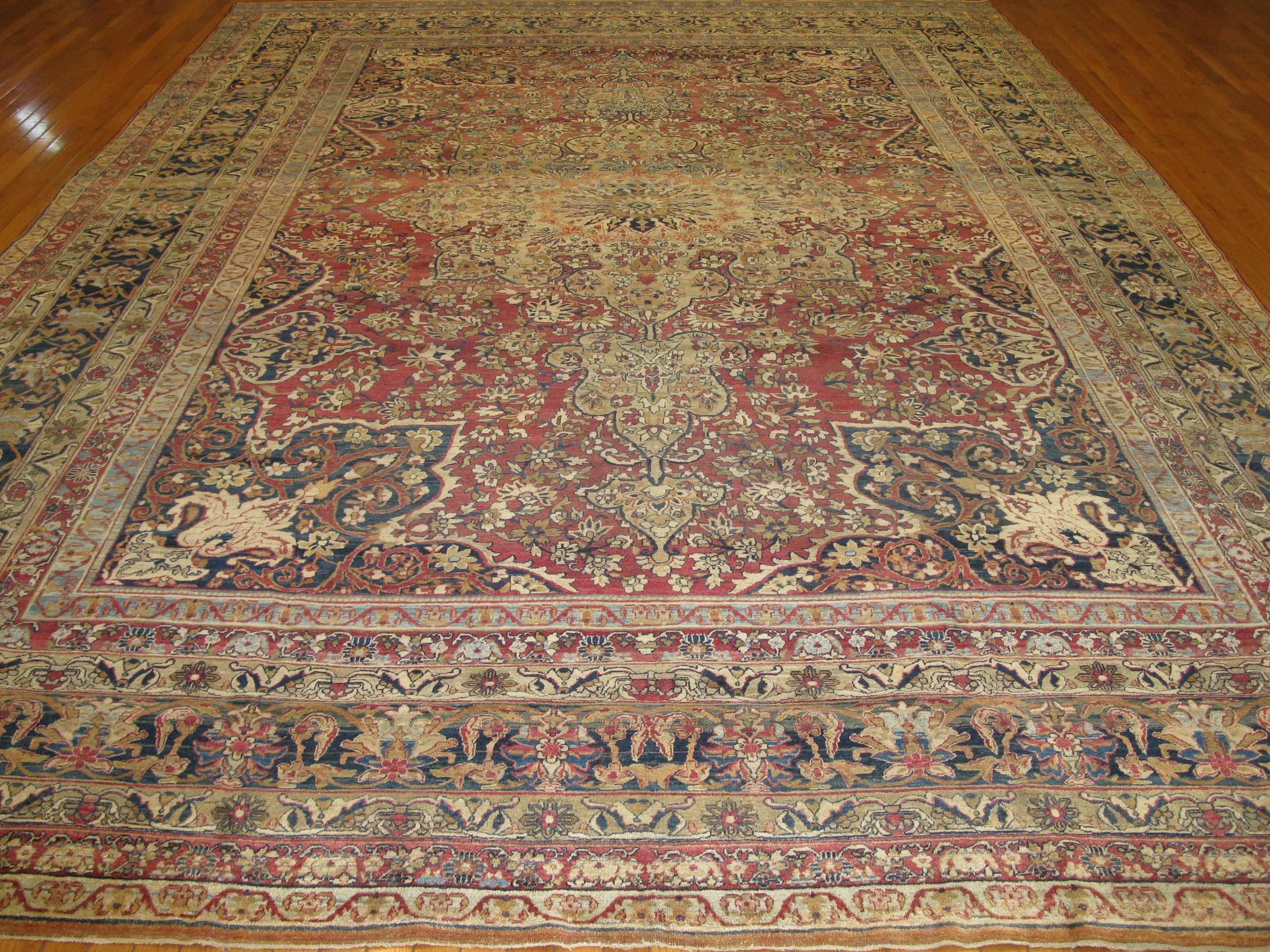 This is a beautiful large room size antique hand-knotted rug from the infamous Lavar Kerman in Iran (Persian). The rug is in excellent condition and measures 10' 3'' x 14' 6''.