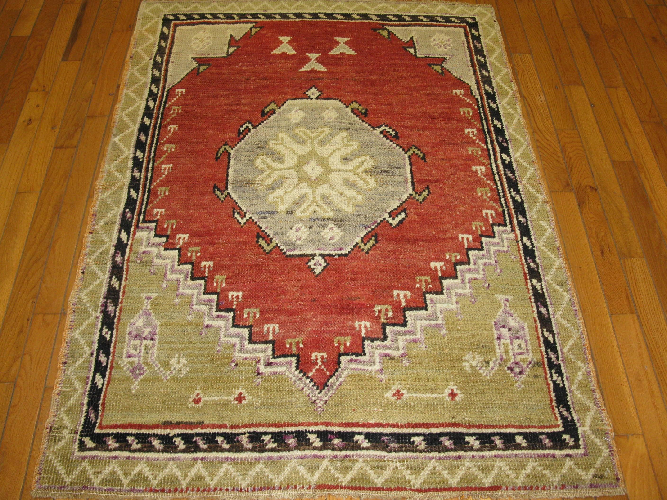 This is a beautiful small hand knotted rug from Turkey. It has a simple tribal design. It is made with good quality wool dyed with rich vegetable dyes. It measures 3' 4'' x 4' 7'' and is in great condition.