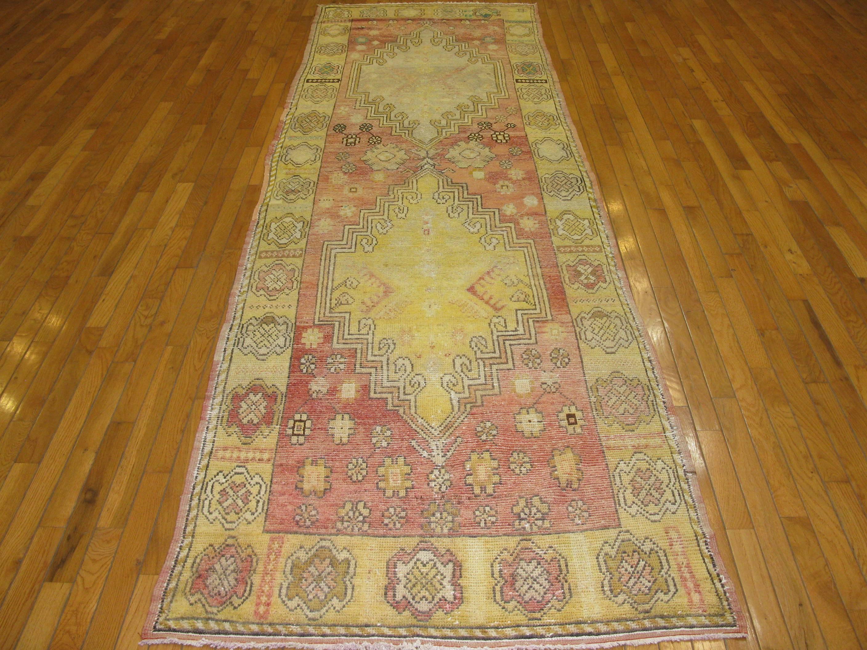 This is a beautiful hand-knotted semi antique Turkish Anatolian Oushak design rug. It has a simple geometric design handmade with wool and all natural dyes. The rug measures 3' 5'' x 11' 3''.