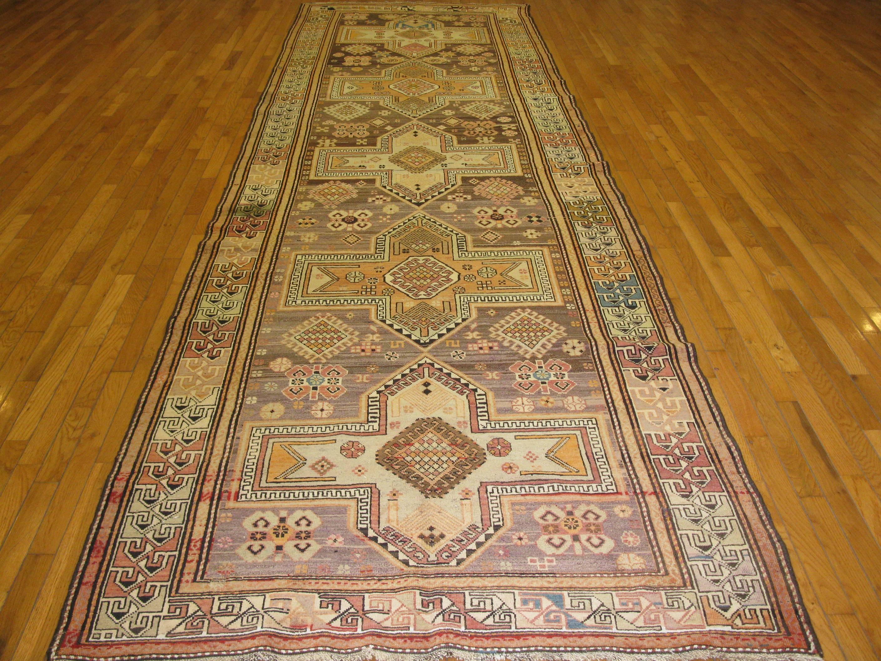 Caucasian Kazak rugs are among the best and most sought after nomadic look rugs of late 19th and early 20th century rugs. This beautiful runner is hand-knotted with all wool and natural dyes. It measures 4' 5'' x 15' 5'' and in great condition.