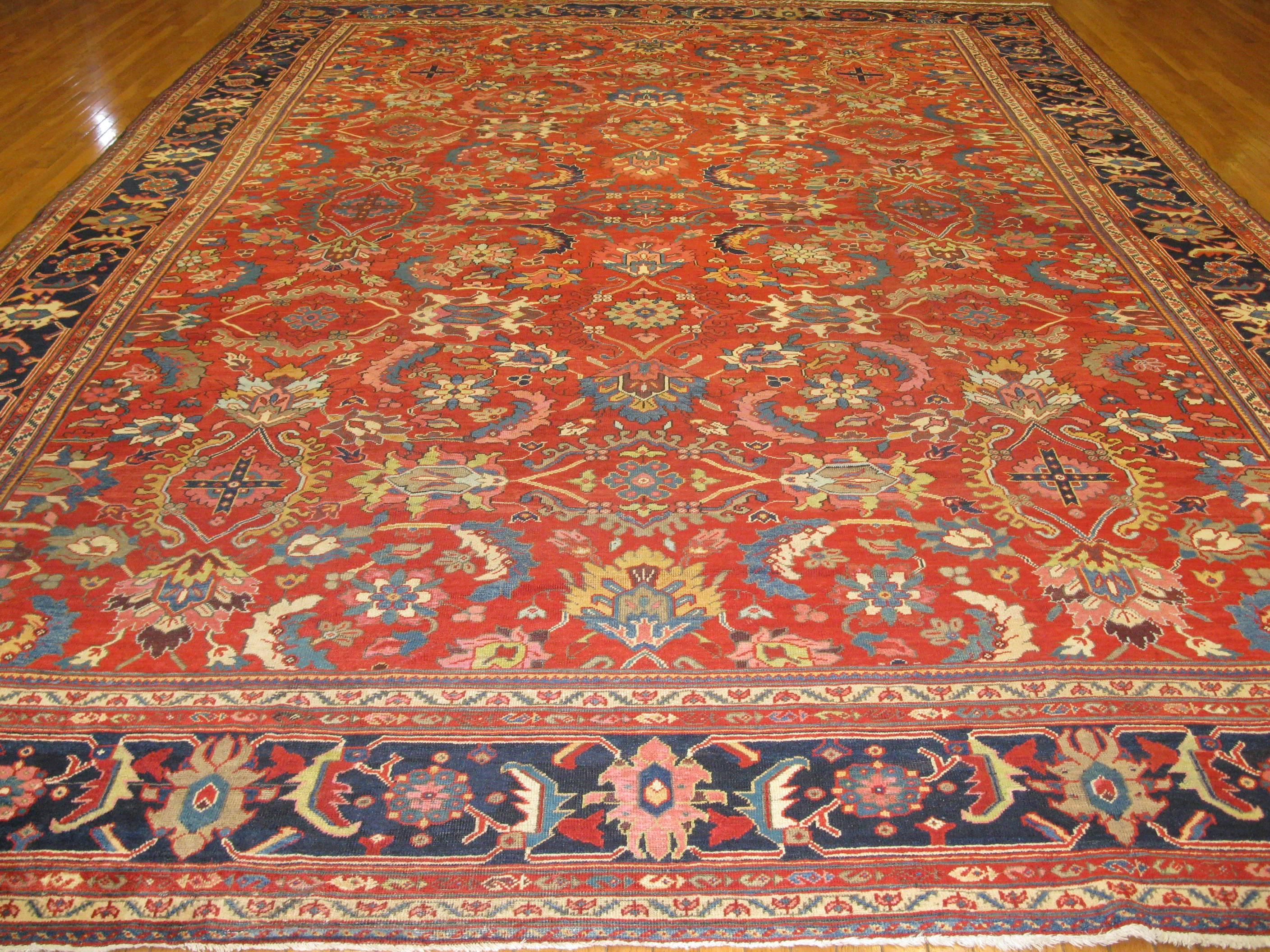 This beautiful handmade rug was made in the village of Mahal near the city of Hamadan in Iran. It is a fine rug with an all-over semi floral pattern on a red field and navy blue border. The rug measures 11' 10'' x 17' 6'' and in great condition.