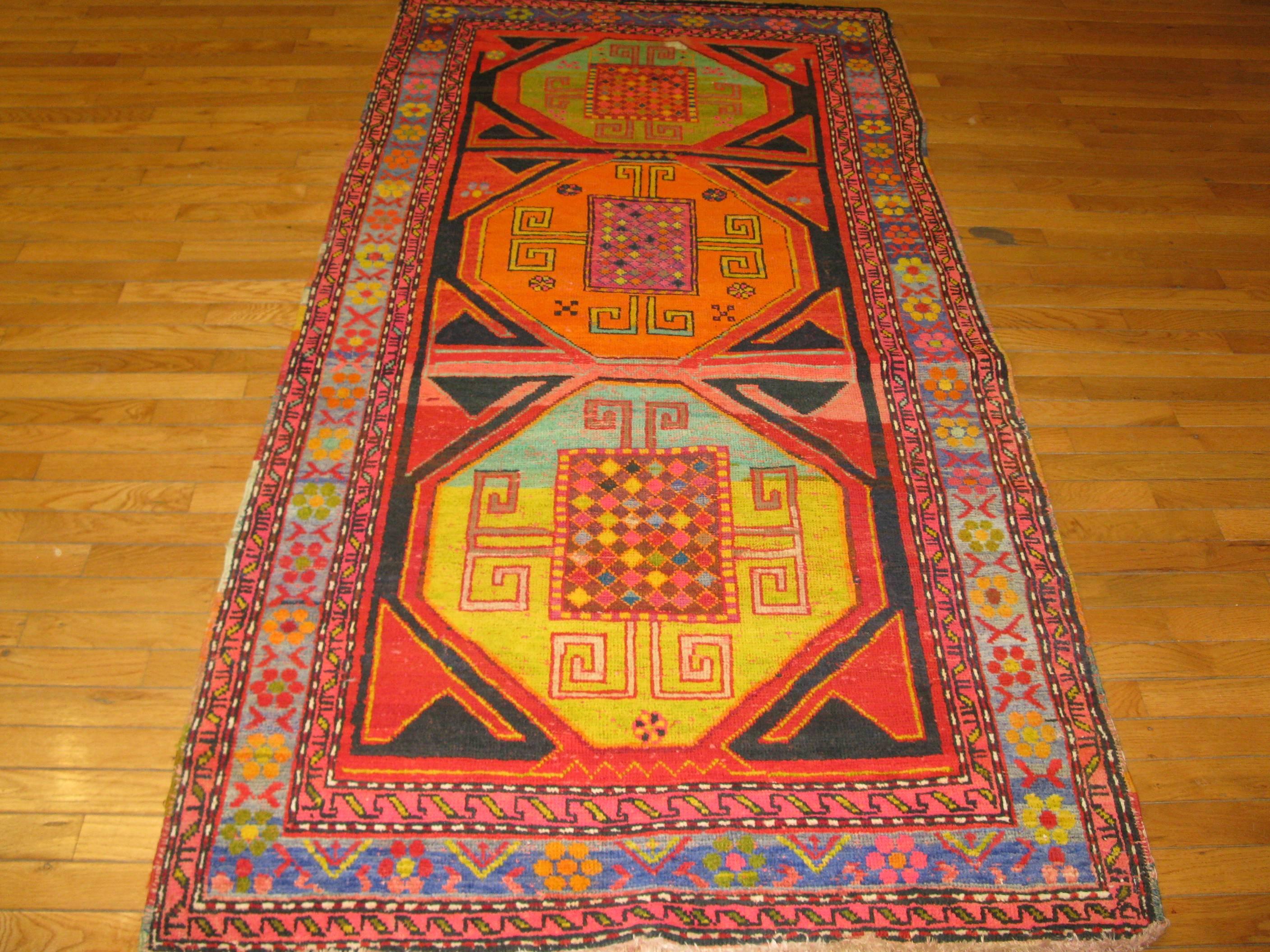 This s a beautiful hand-knotted rug with a tribal Karabag design from the Eastern Anatolian region of Turkey. The rug has rich vibrant color combination, wool pile and cotton foundation. It measures 3' 7'' x 7' 2''.