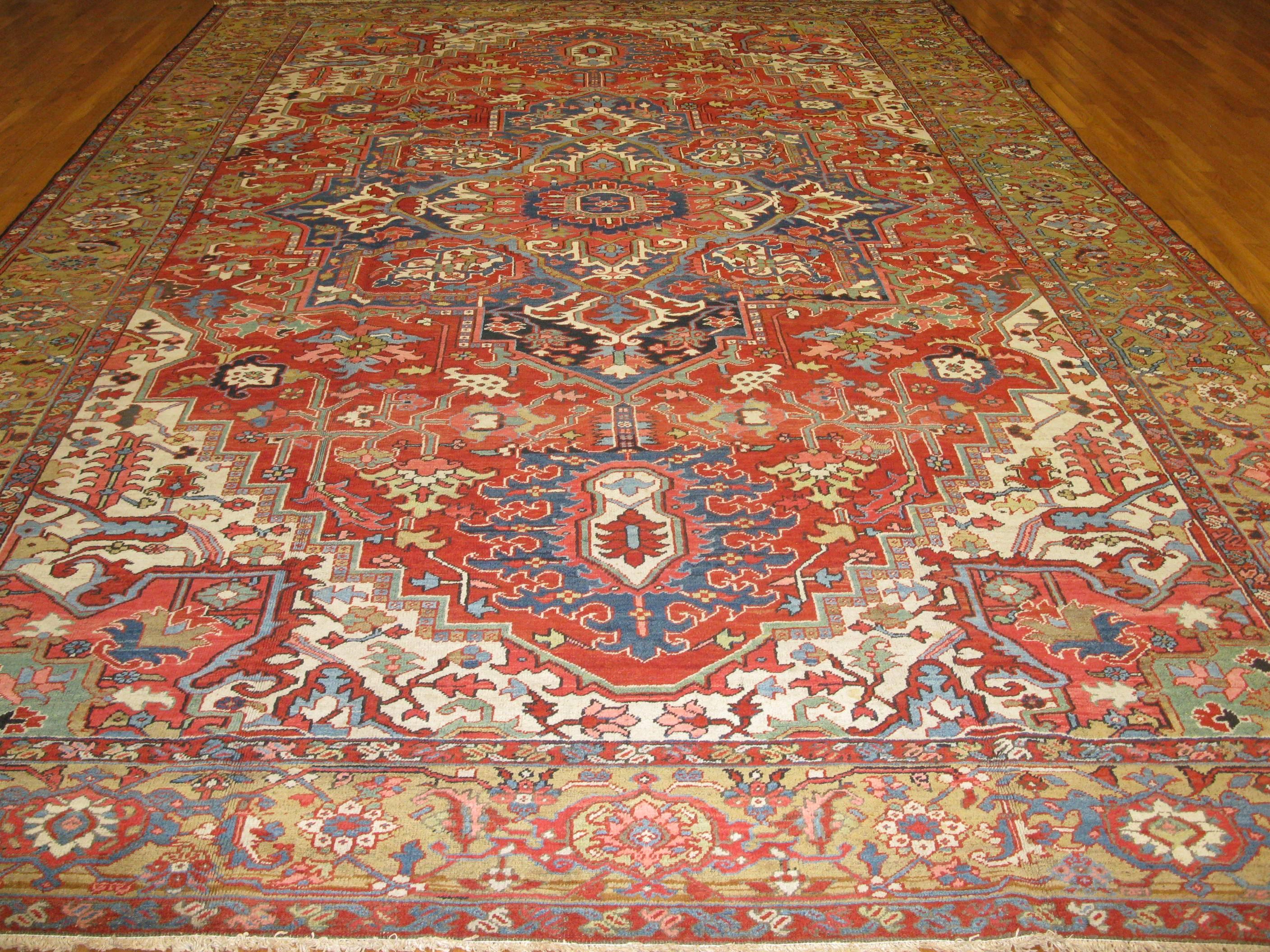 This is an antique hand-knotted rug for the village of Heriz in northwest Iran. The rug has a traditional geometric design made with wool pile, cotton foundation and all vegetable dyes. It measures 11' x 16' 6'' and is in great condition.