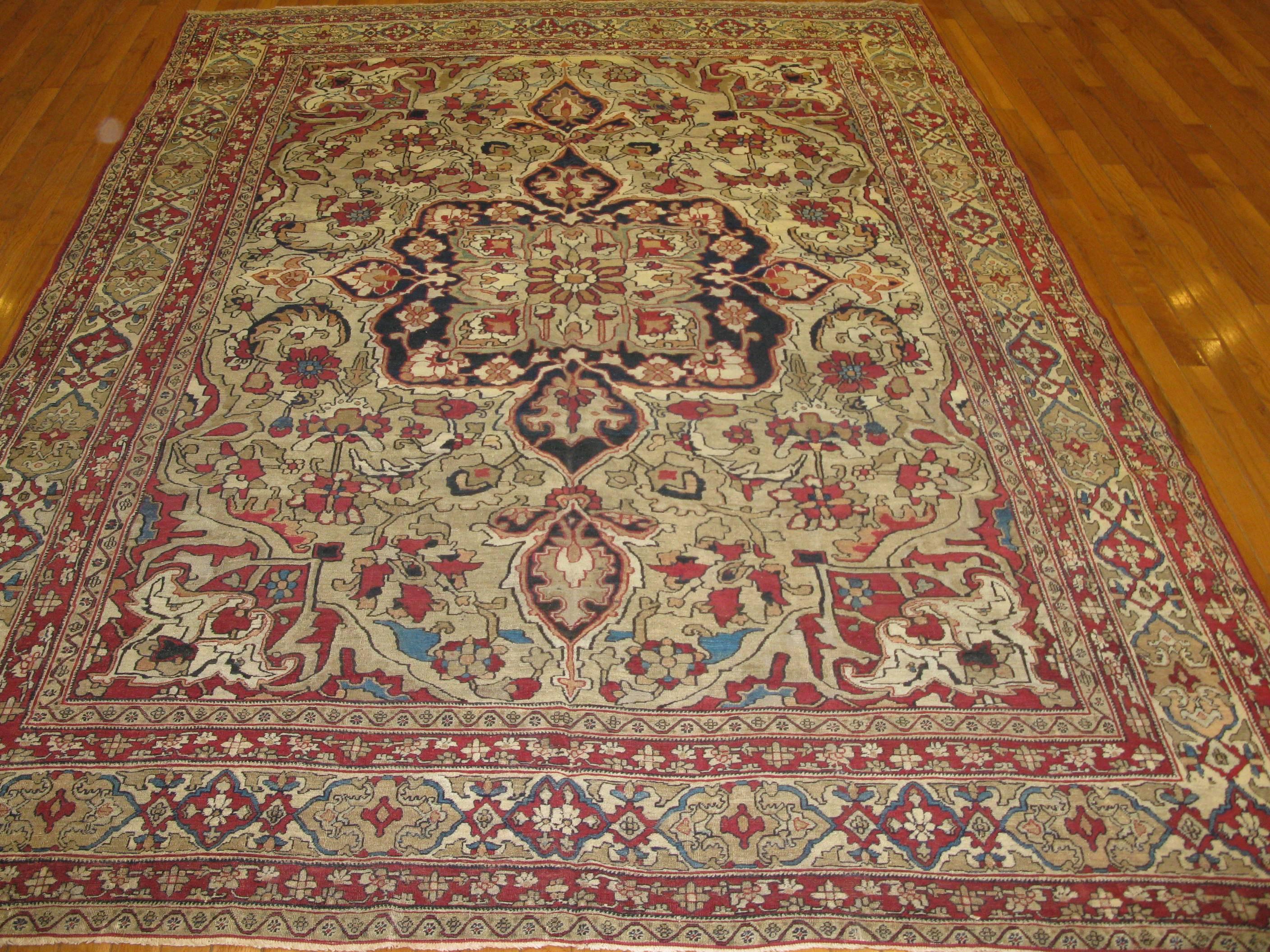 This is a beautiful and hard to find mid-size antique hand-knotted Persian Lavar Kerman rug. It has a fine weave with an intricate floral pattern on a mushroom color background. The rug measures 6' 9'' x 9' 4'' and in great condition.