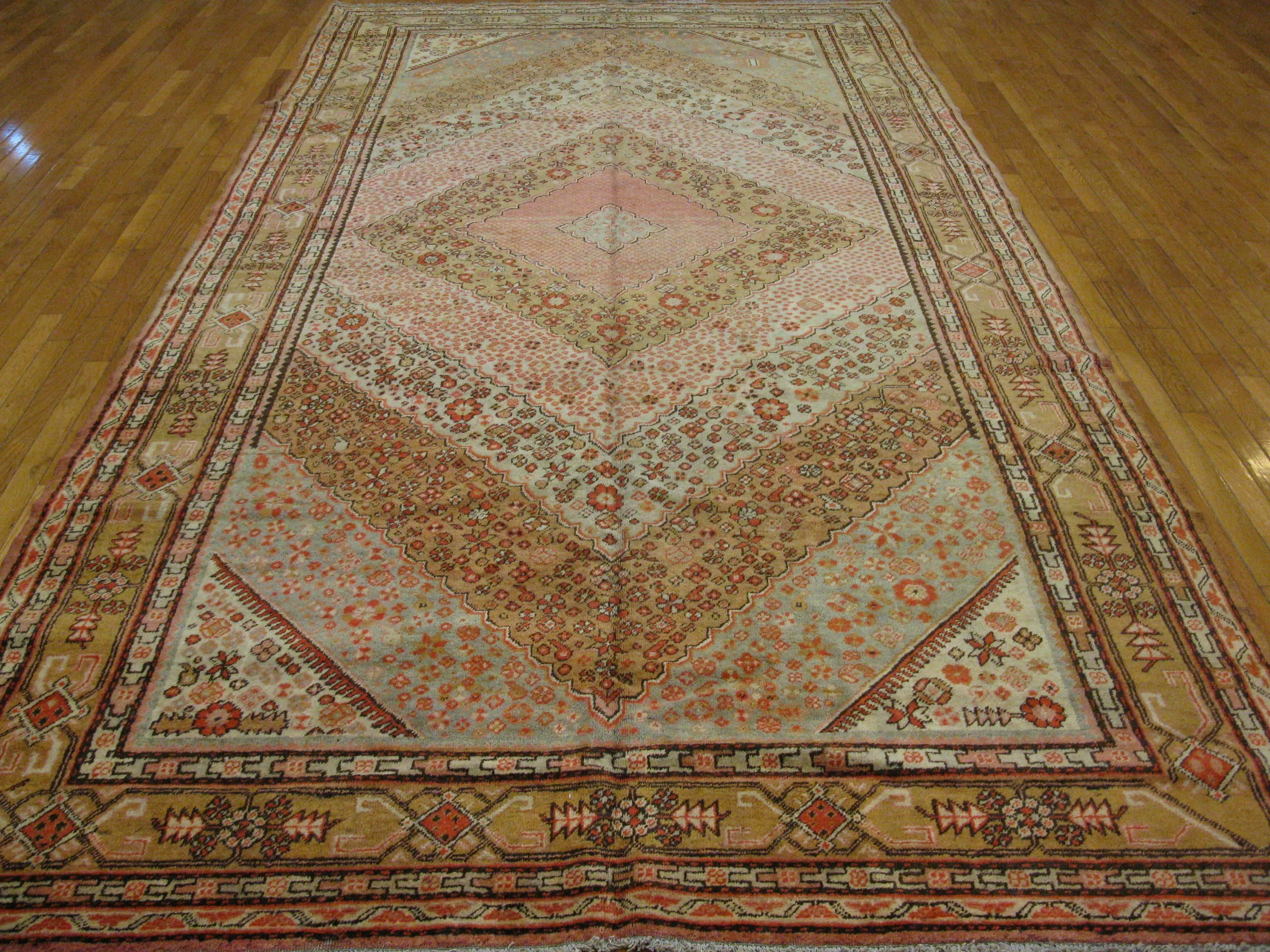 This is a well balanced and outstanding antique hand-knotted Khotan rug. The rug measures 6' 8'' x 13' handmade with wool and natural dyes. It is in great condition.