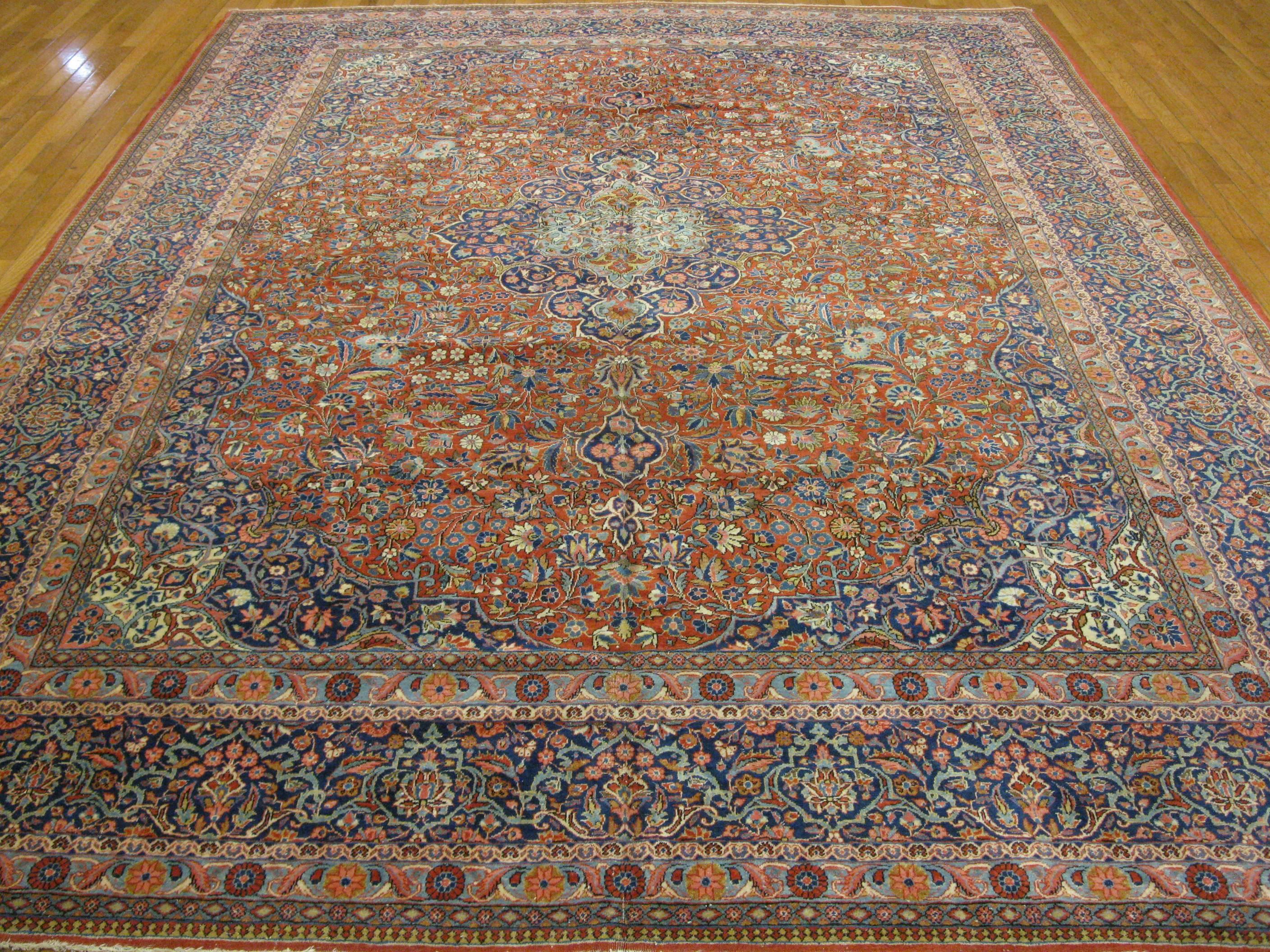 This is a fantastic example of the infamous antique Persian Kashan rugs. 
The rug has intricate traditional floral design made with fine wool and natural dyes. It measures 8' 8