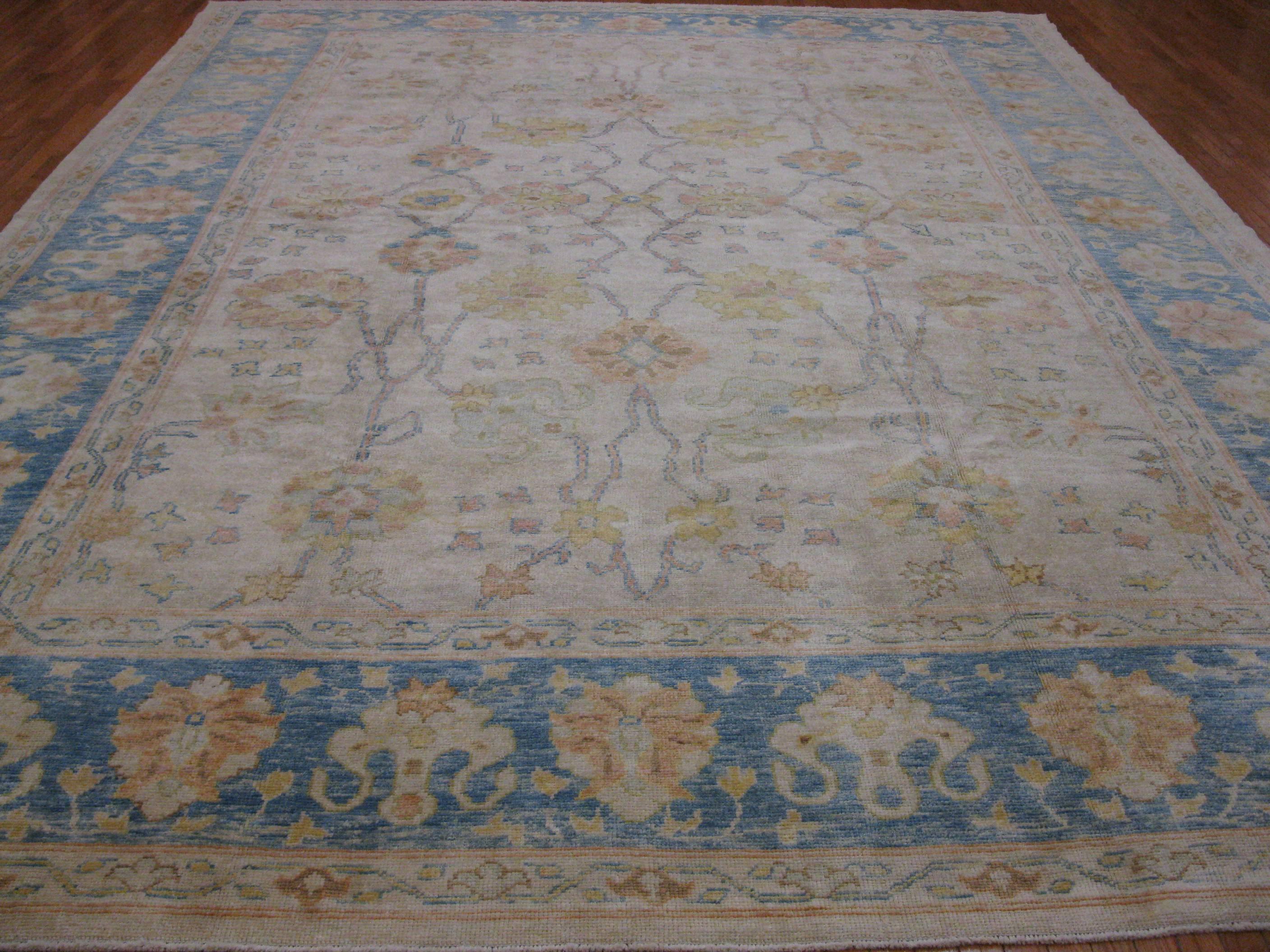 This is a beautiful large room size hand-knotted antique look Turkish Oushak rug with an easy to use all-over pattern. The rug is made with all natural wool and vegetable dyes. It measures 11' 2'' x 14' 10''.