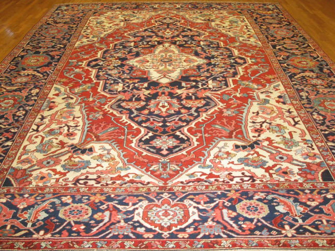 This is a fantastic hand-knotted antique Persian Serapi rug with the Classic geometric central and corner medallion design. The rug is finely handmade with wool nas natural dyes. It measures 10' 6'' x 13' 3.