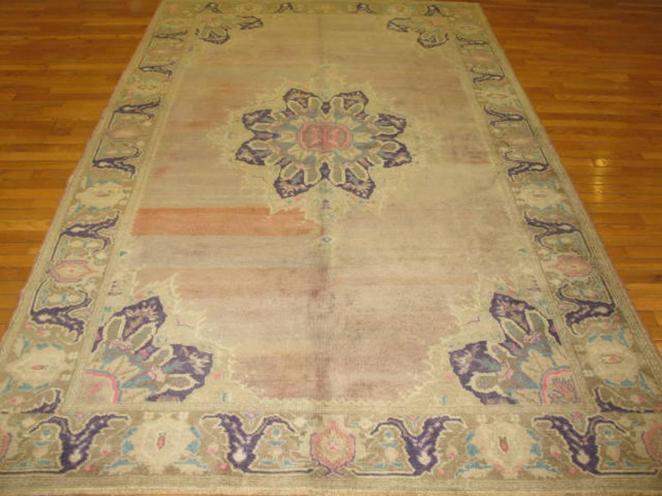 This is a hand-knotted rug from in Turkey. This beautiful rug is made with wool and natural dyes antique washed for softer colors. It measures 5' 9'' x 9' 7'' and is in great condition.
