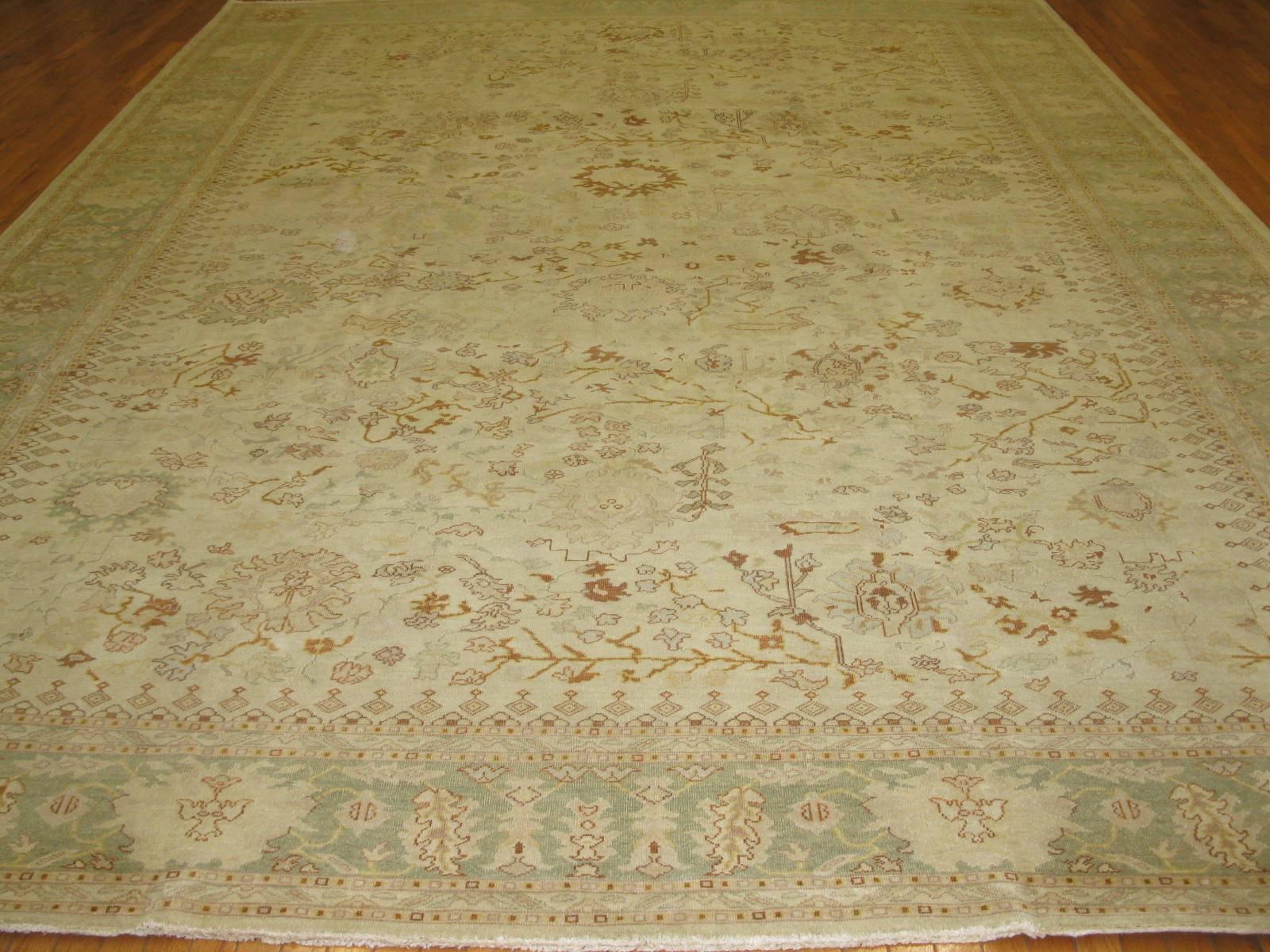This is a beautiful antique washed hand-knotted rug made in Egypt with an all-over pattern Agra design. The rug has a very fine weave with a great antique patina. It measures 11' x 14' 9''.