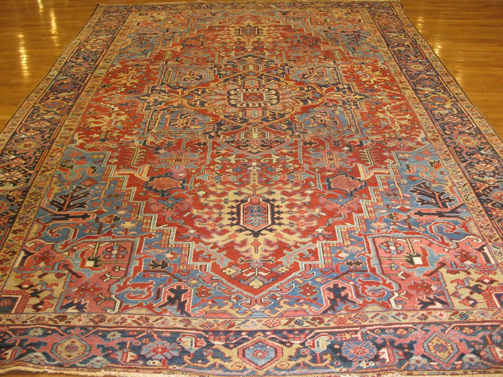 This is a beautiful and finely hand-knotted antique Persian Heriz rug. It is made with wool colored with natural dyes that has softened with age. The rug measures 9' x 13' and in great condition.