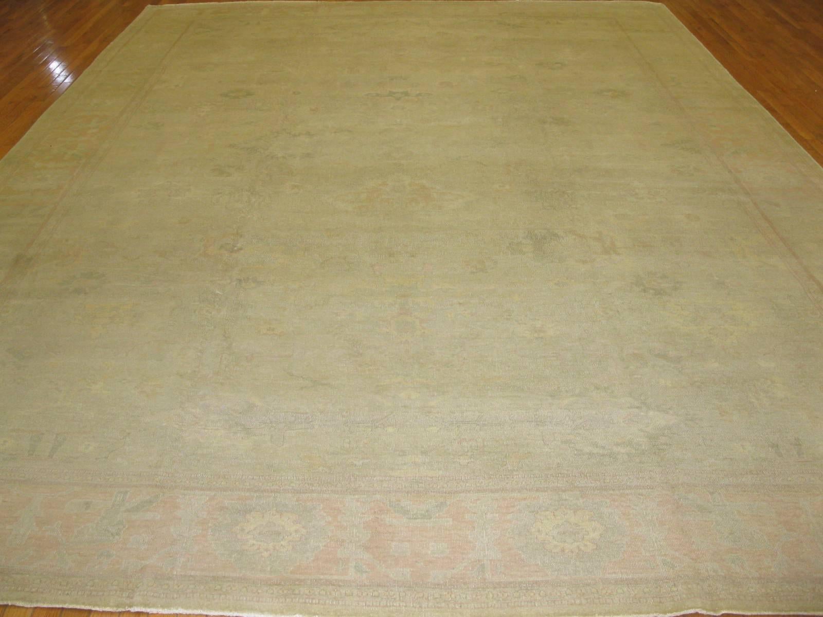This is a beautiful antique washed hand-knotted rug made in Egypt with an all-over pattern Oushak design. The rug has a very fine weave with a great antique patina. It measures 10'9'' x 14'9''.
