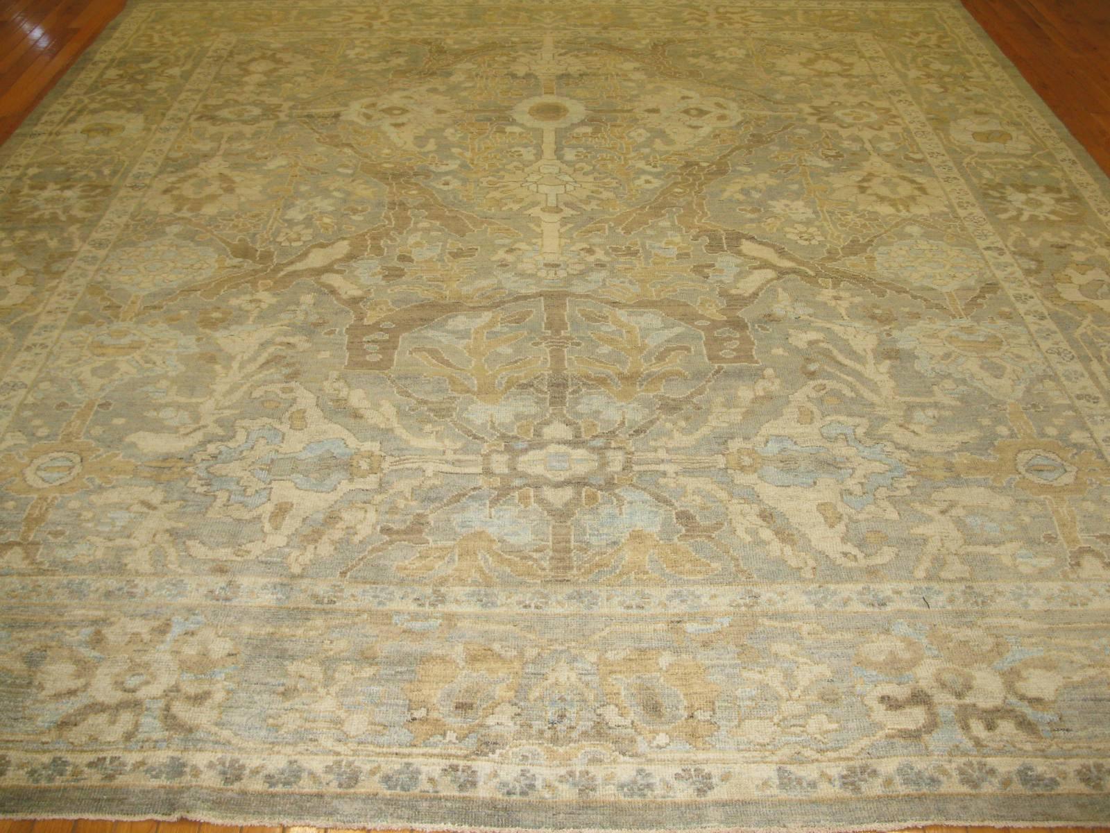 This is a fabulous contemporary hand-knotted rug is made in the spirit of the original antique Persian Sultanabad rugs. The rug is made with wool colored with natural dyes and textures to capture the patina of the antique rugs. The rug measures 10'