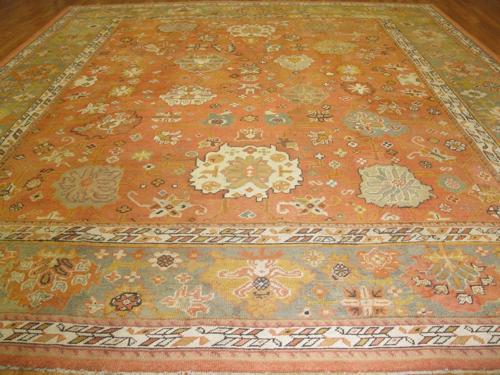 This is a beautiful genuine antique hand-knotted Turkish Oushak rug with a large-scale all-over pattern making it a very easy rug to work with. The rug measures 14' x 16' 6'' and in great condition.