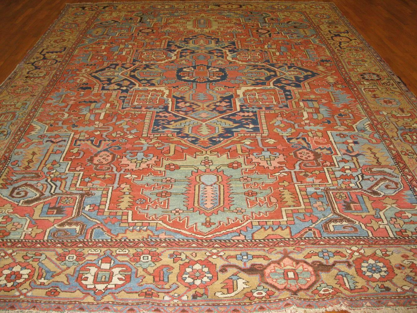 This is a fantastic antique hand-knotted Persian Heriz rug with a very fine weave made wit h wool and all natural dyes. It has a very pleasing color combination with little nave blue. The rug measures 10' x 13' 3